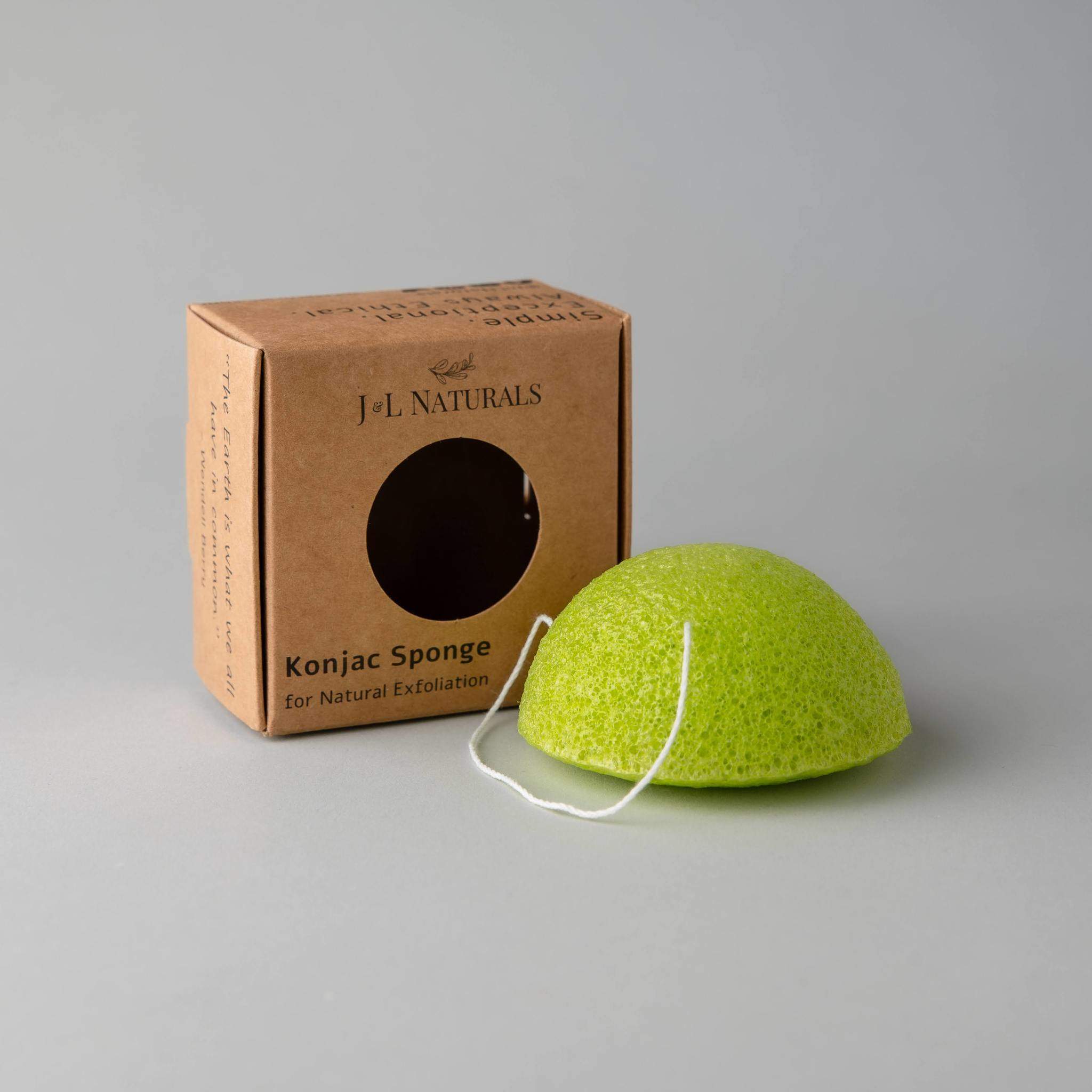 A collection of five biodegradable Konjac sponges in various colors, each representing different skin benefits, displayed on a natural wooden surface.