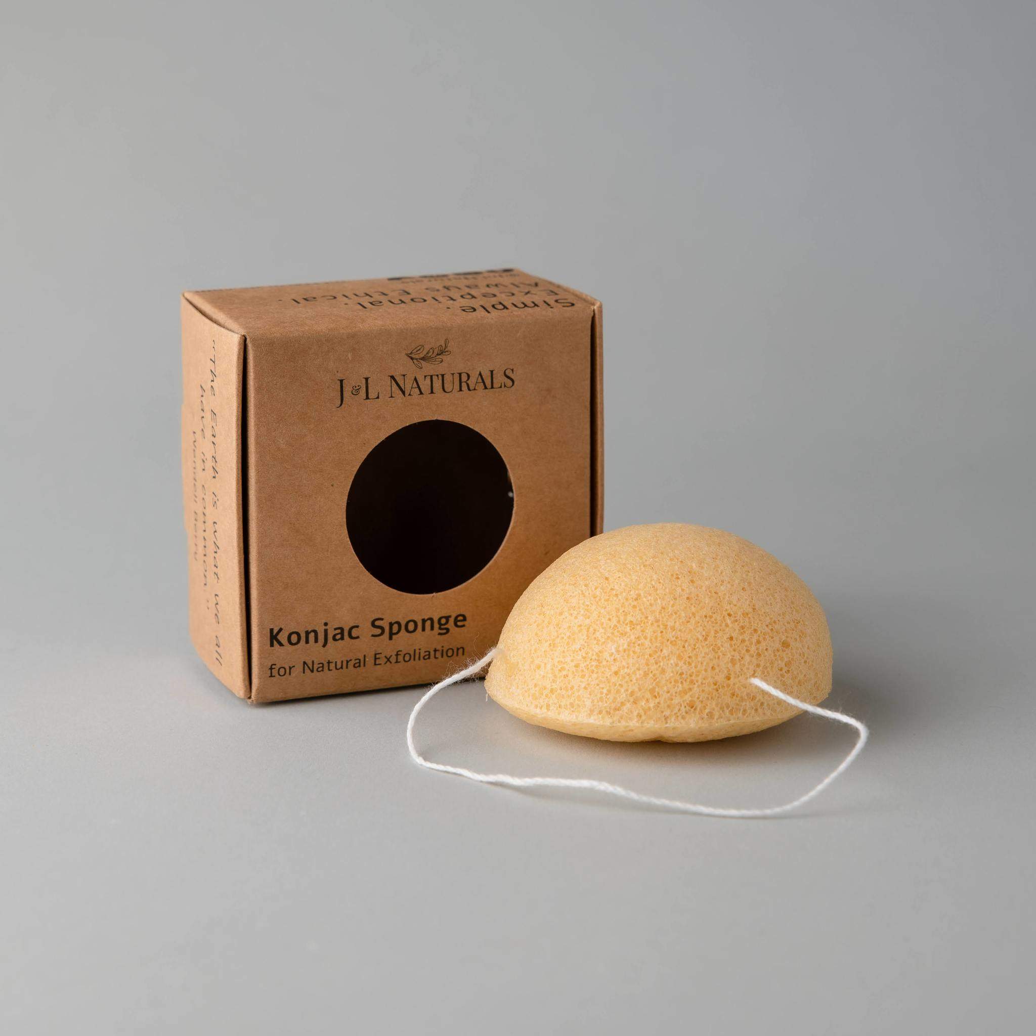 A collection of five biodegradable Konjac sponges in various colors, each representing different skin benefits, displayed on a natural wooden surface.