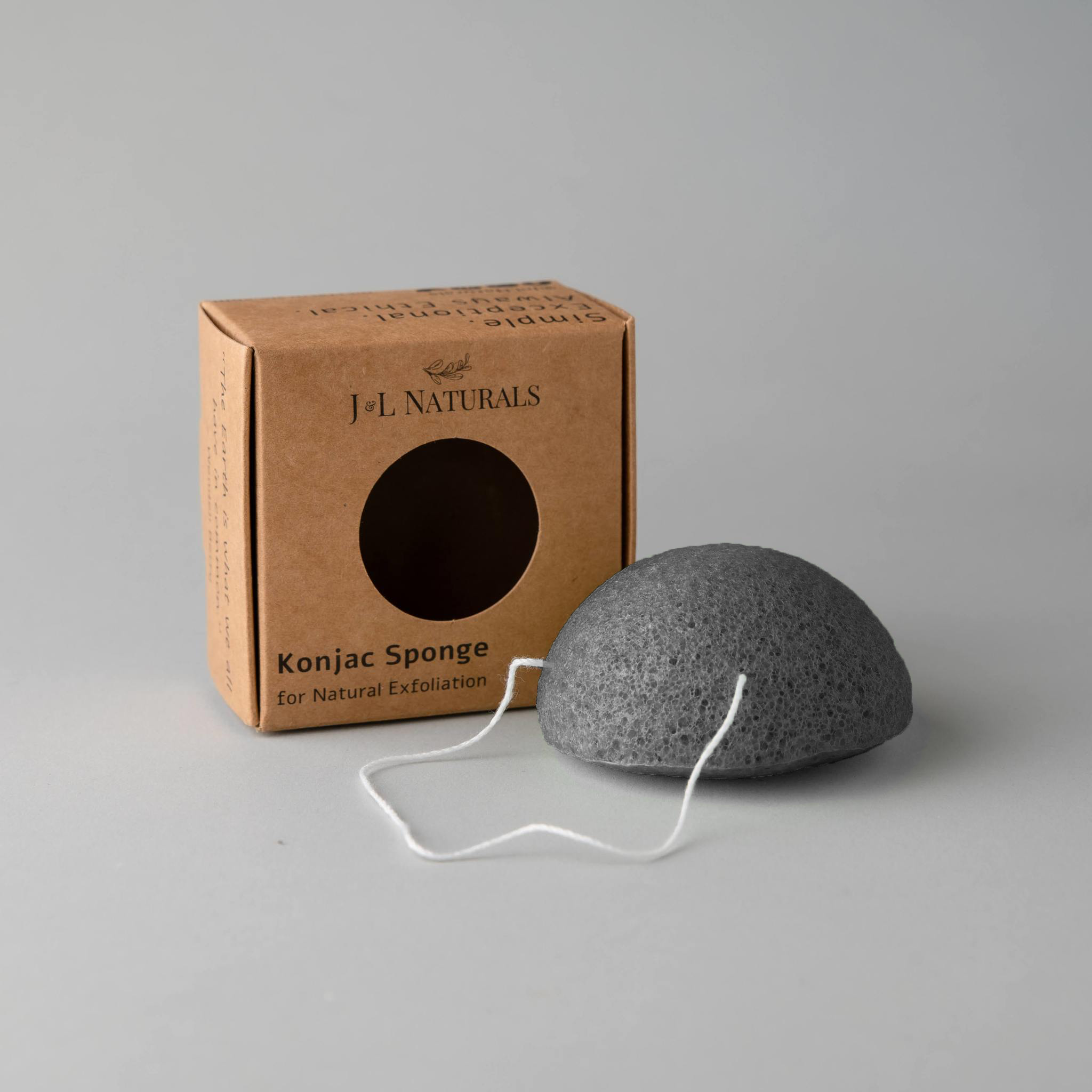 A collection of five biodegradable Konjac sponges in various colors, each representing different skin benefits, displayed on a natural wooden surface.