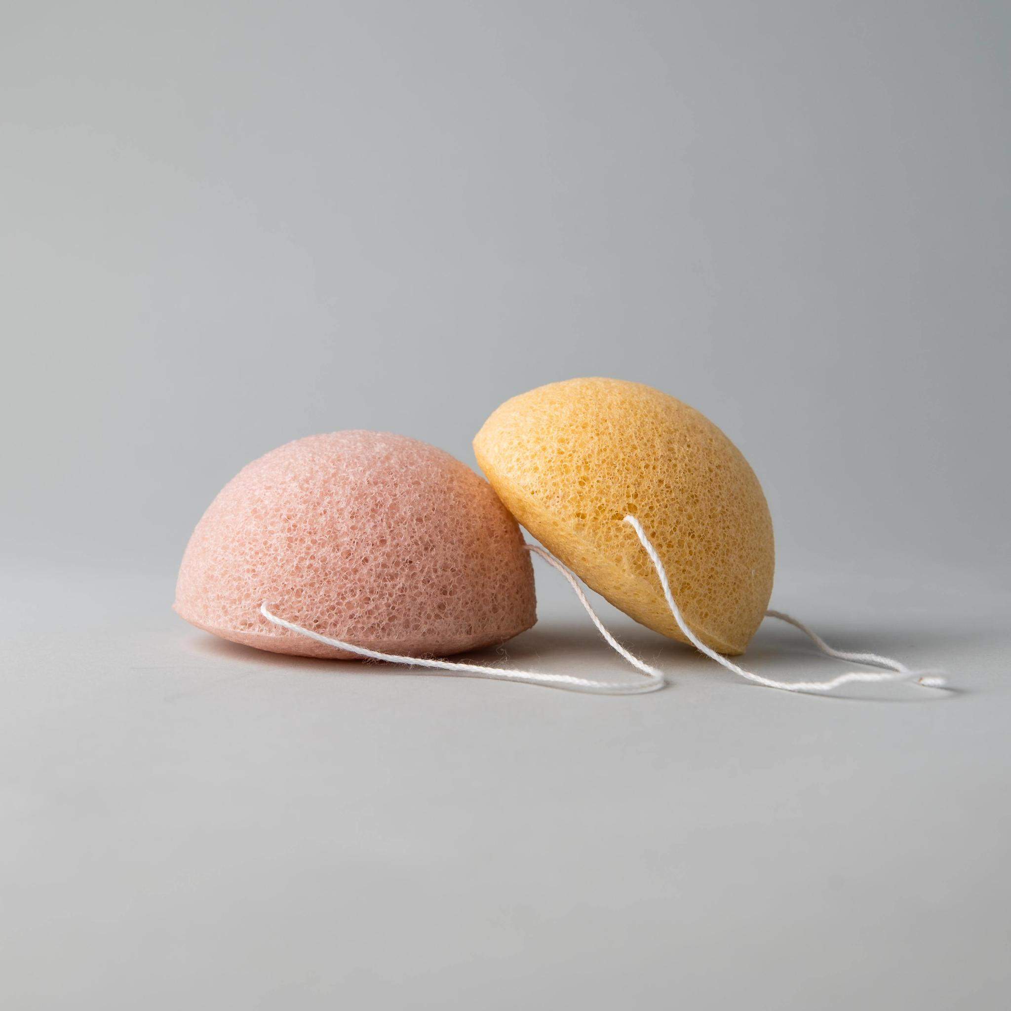 Two biodegradable Konjac sponges in various colors for different skin types, showcasing their natural texture and eco-friendly design.