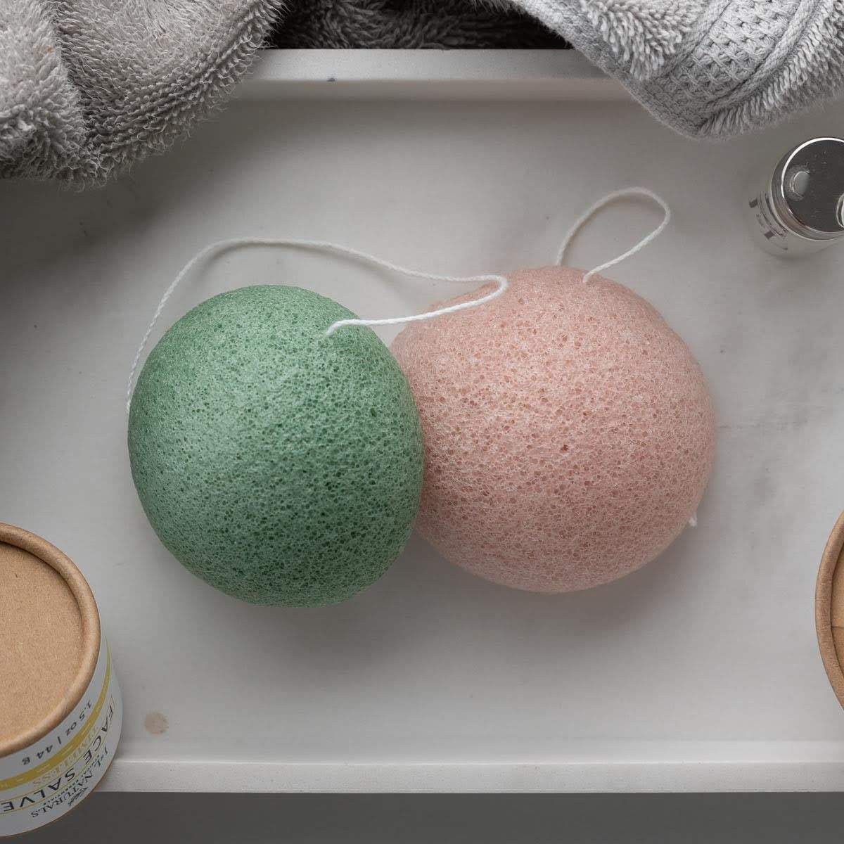 Two biodegradable Konjac sponges in various colors for different skin types, showcasing their natural texture and eco-friendly design.