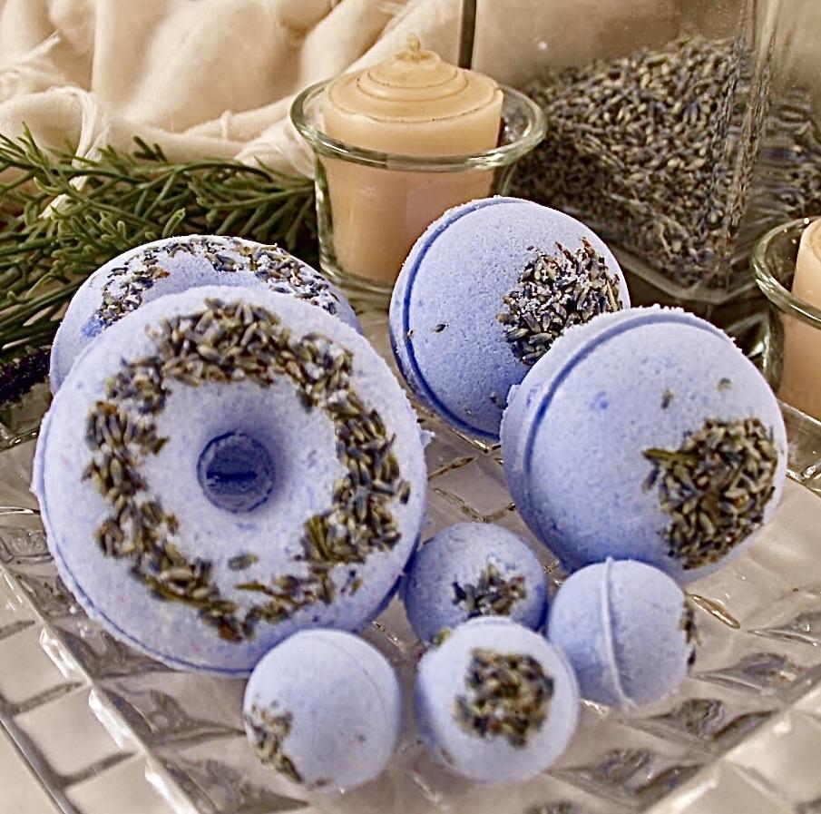 Lavender Blossom Bath Bomb in vibrant colors, surrounded by lavender petals, showcasing its luxurious and soothing properties.