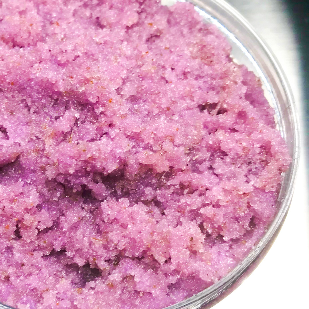 A jar of Lavender Martini Sugar Scrub with a whipped foaming texture, showcasing its lavender color and sugar granules, perfect for exfoliating and hydrating skin.