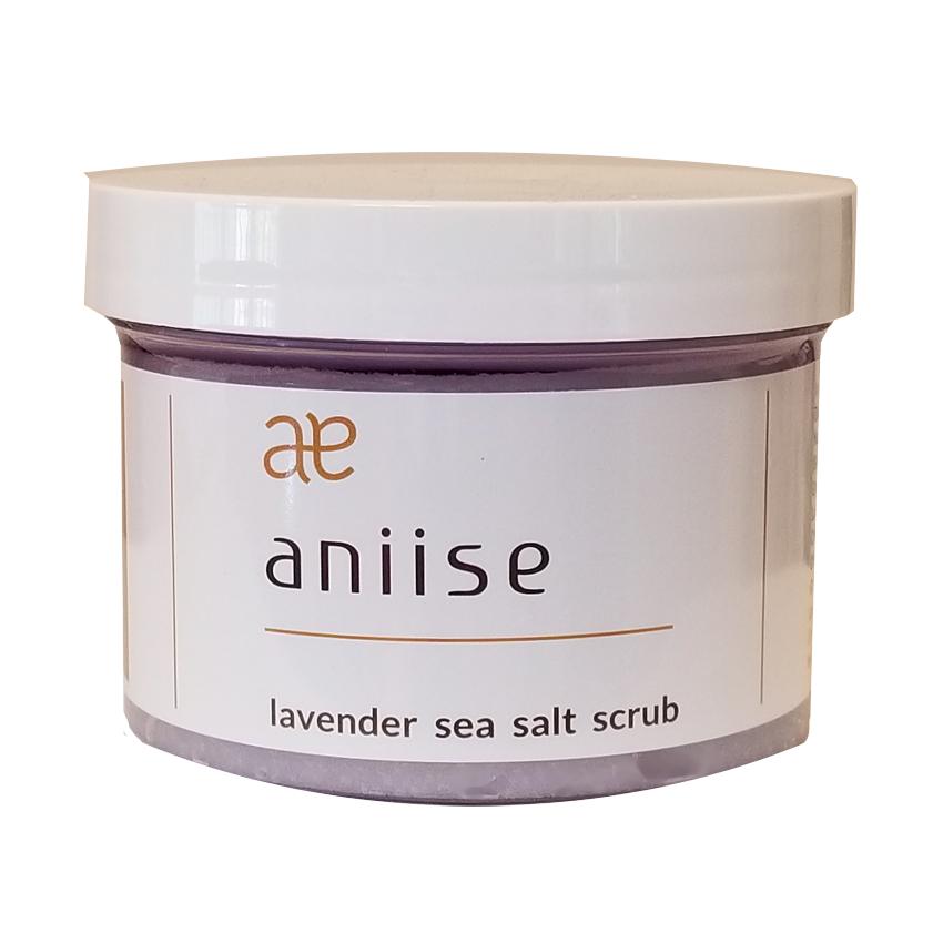 A jar of Lavender Sea Salt Scrub with a lavender flower beside it, showcasing its natural ingredients and soothing properties.