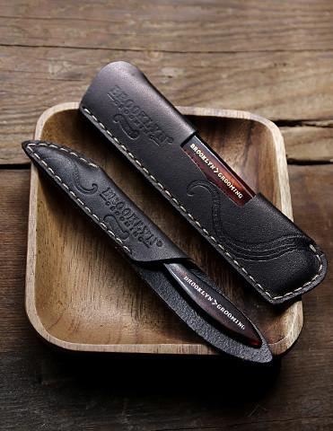 Leather Mustache-Beard Comb Sleeve in black with gold stitching, showcasing its premium quality and craftsmanship.