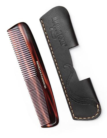 A handcrafted leather pocket comb sleeve in black with gold stitching, showcasing its premium quality and elegant design.