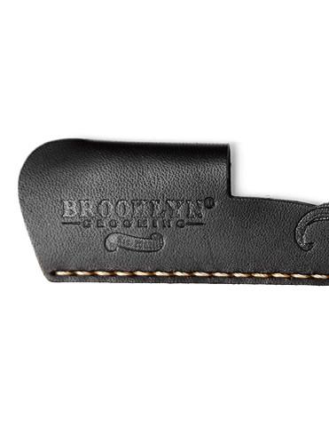 A handcrafted leather pocket comb sleeve in black with gold stitching, showcasing its premium quality and elegant design.