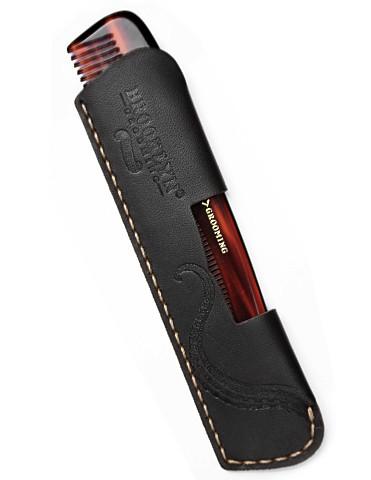 A handcrafted leather pocket comb sleeve in black with gold stitching, showcasing its premium quality and elegant design.