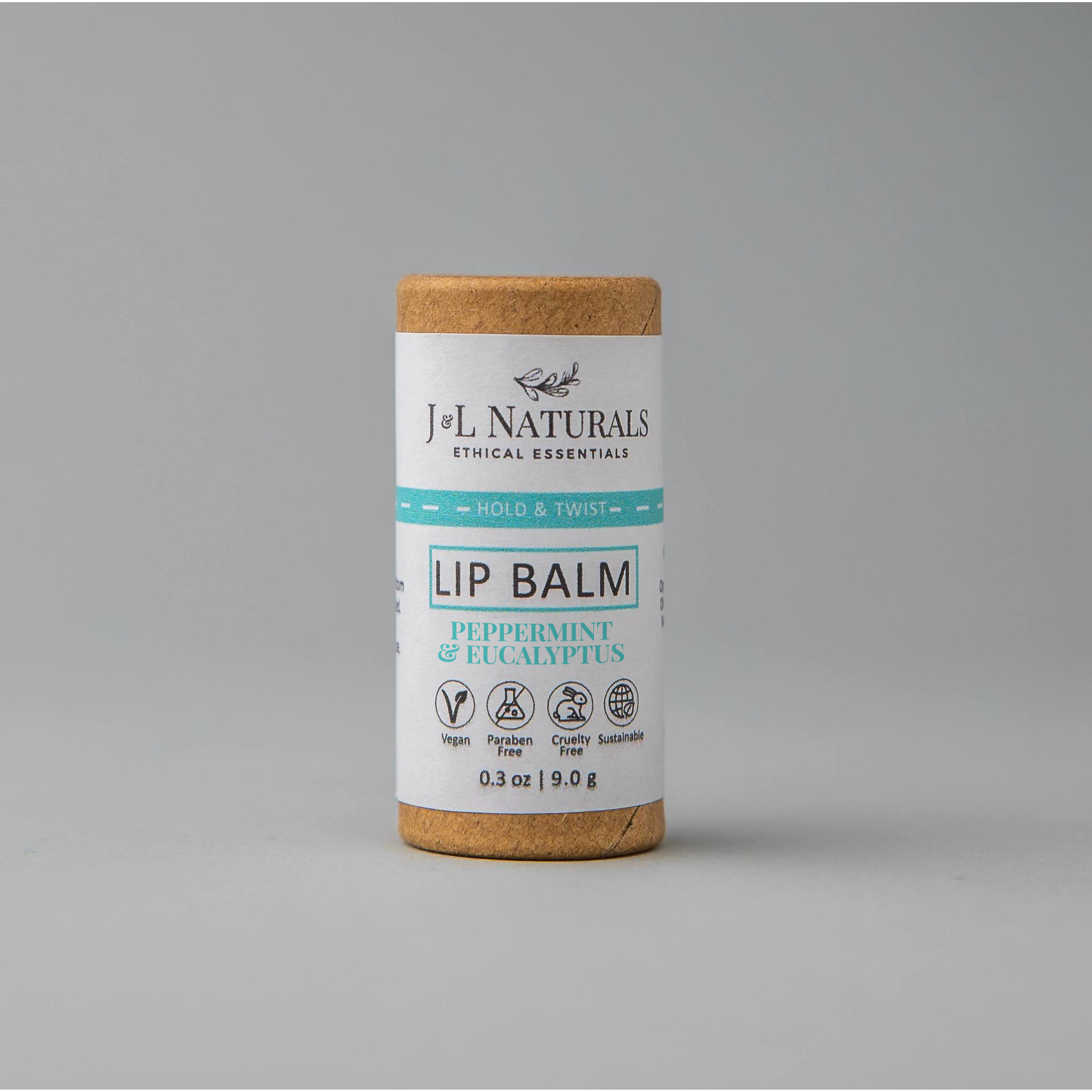 A collection of six lip balms in various flavors including unscented, peppermint, lemongrass, strawberry, bergamot, and lemon, displayed on a wooden surface.