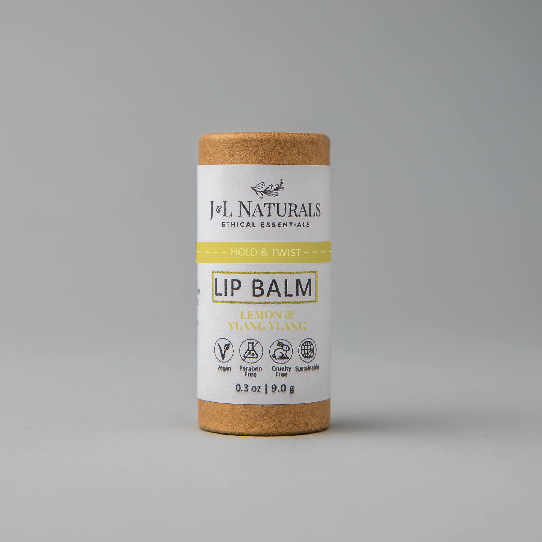 A collection of six lip balms in various flavors including unscented, peppermint, lemongrass, strawberry, bergamot, and lemon, displayed on a wooden surface.