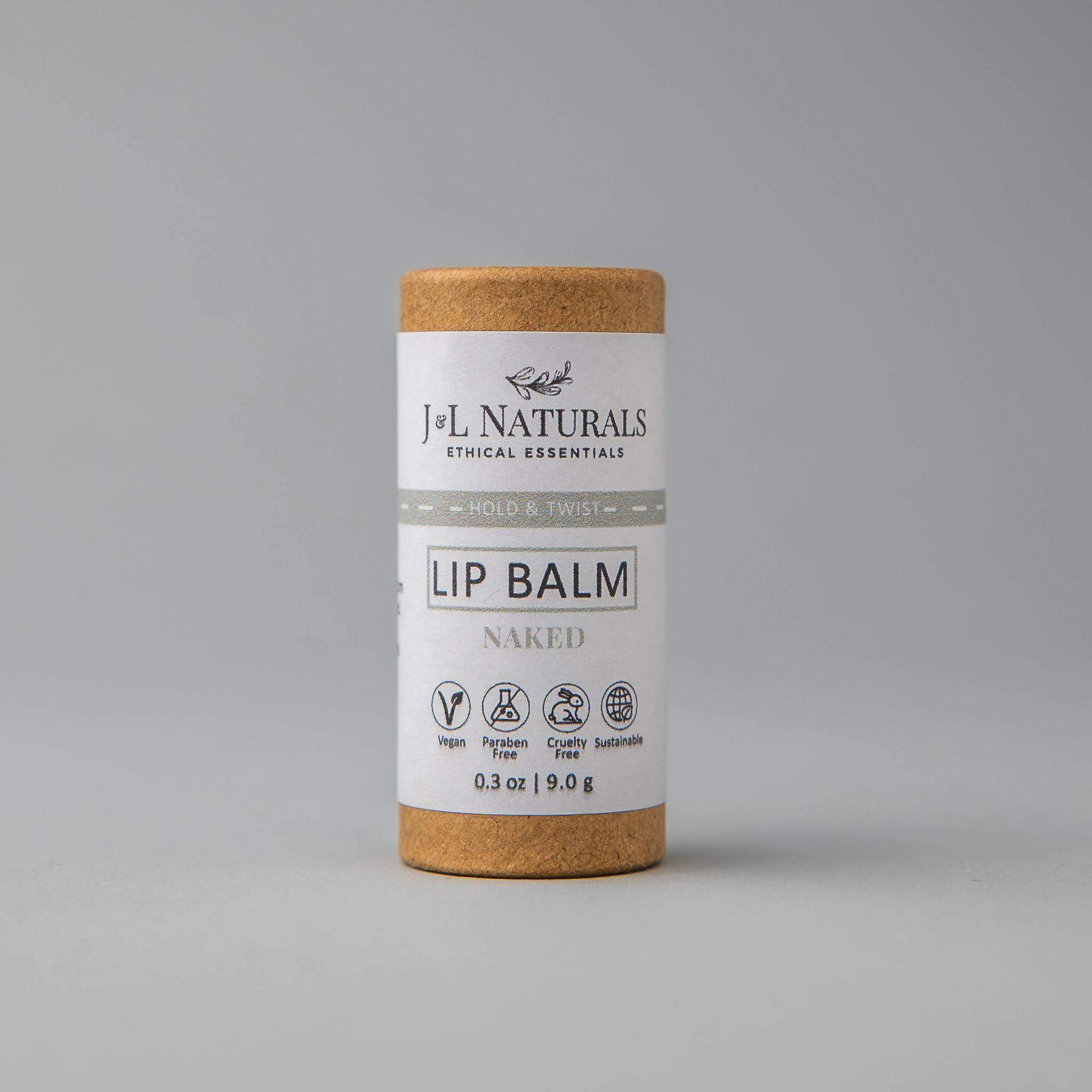 A collection of six lip balms in various flavors including unscented, peppermint, lemongrass, strawberry, bergamot, and lemon, displayed on a wooden surface.