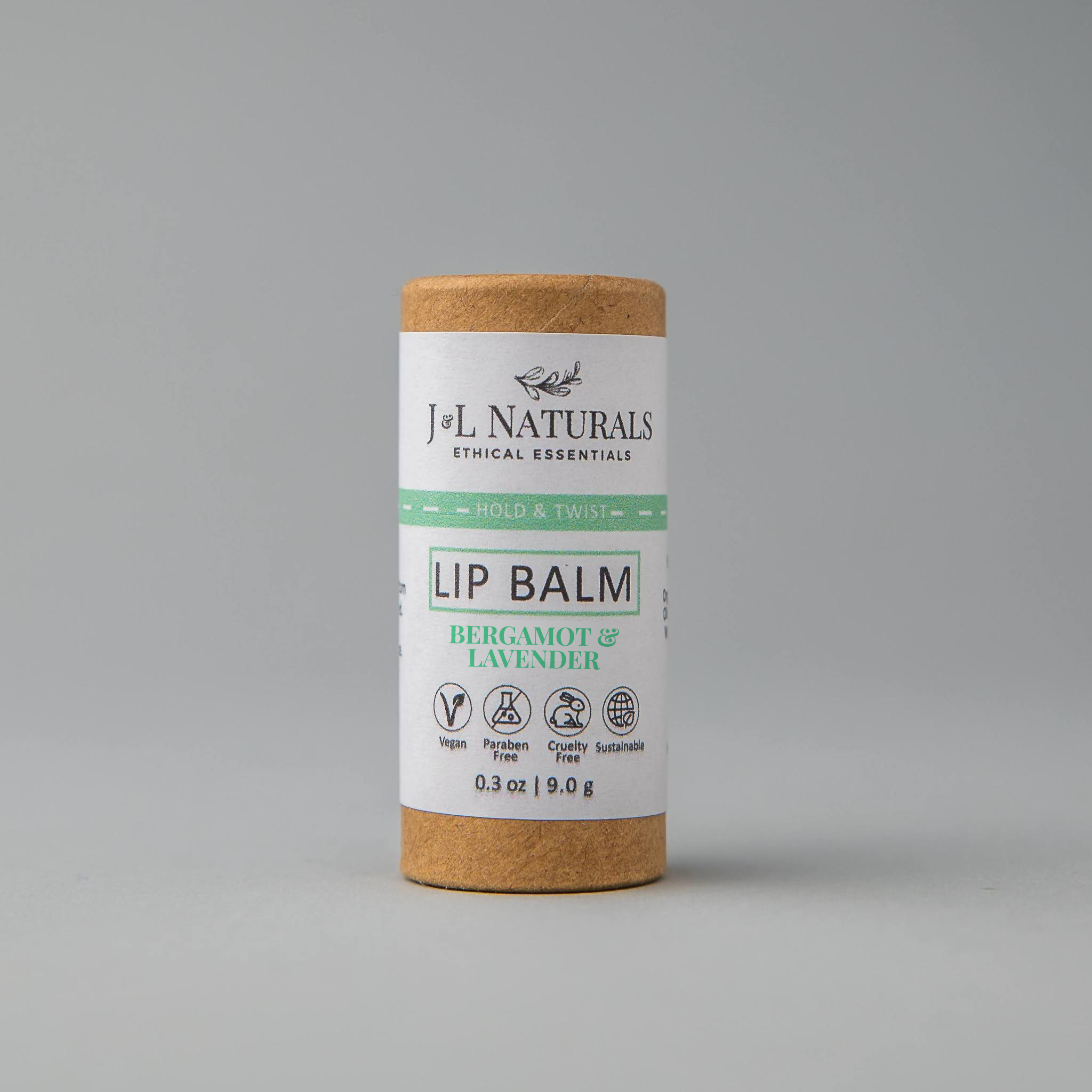 A collection of six lip balms in various flavors including unscented, peppermint, lemongrass, strawberry, bergamot, and lemon, displayed on a wooden surface.