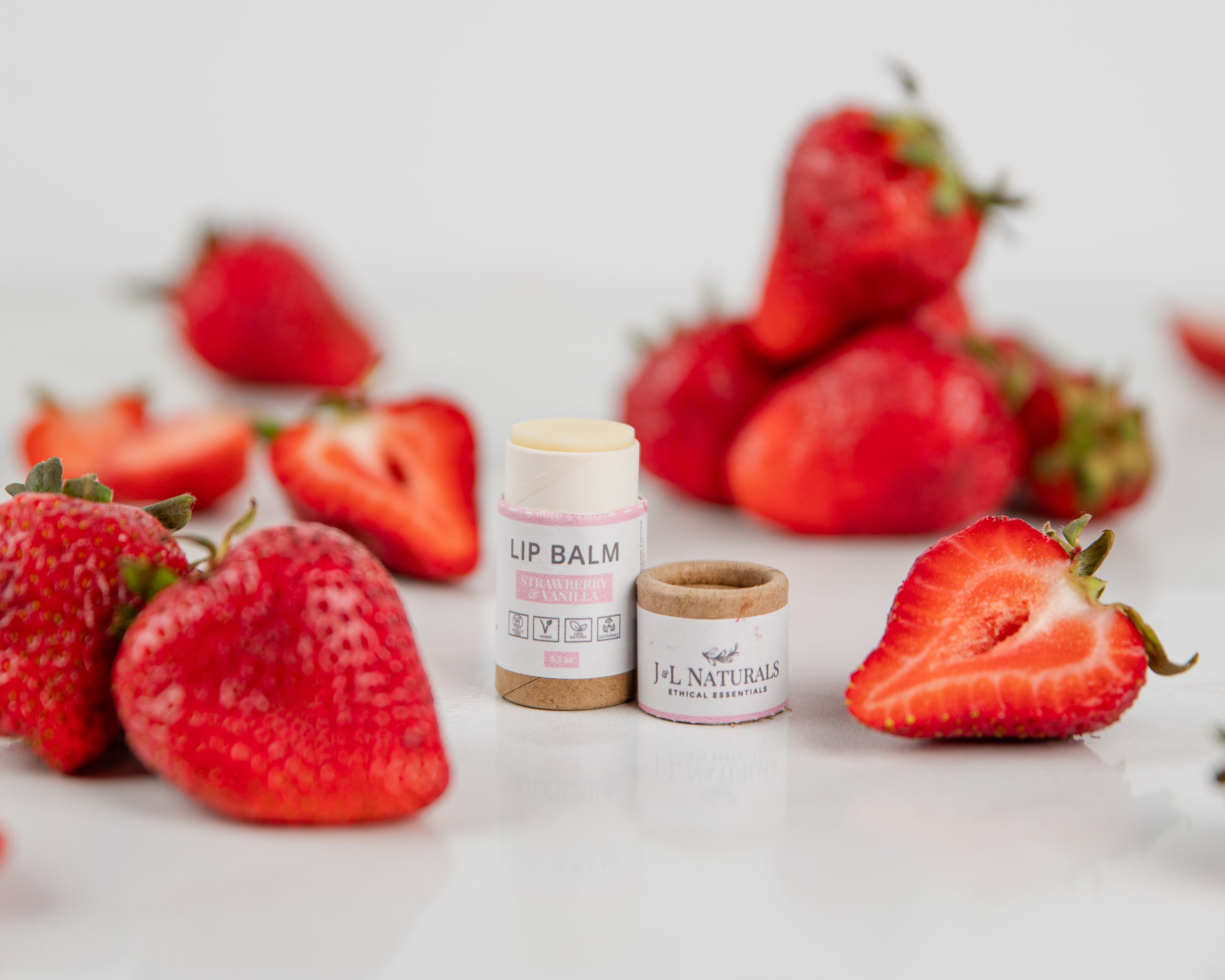 A collection of five lip balms in various flavors, showcasing their vibrant packaging and natural ingredients.