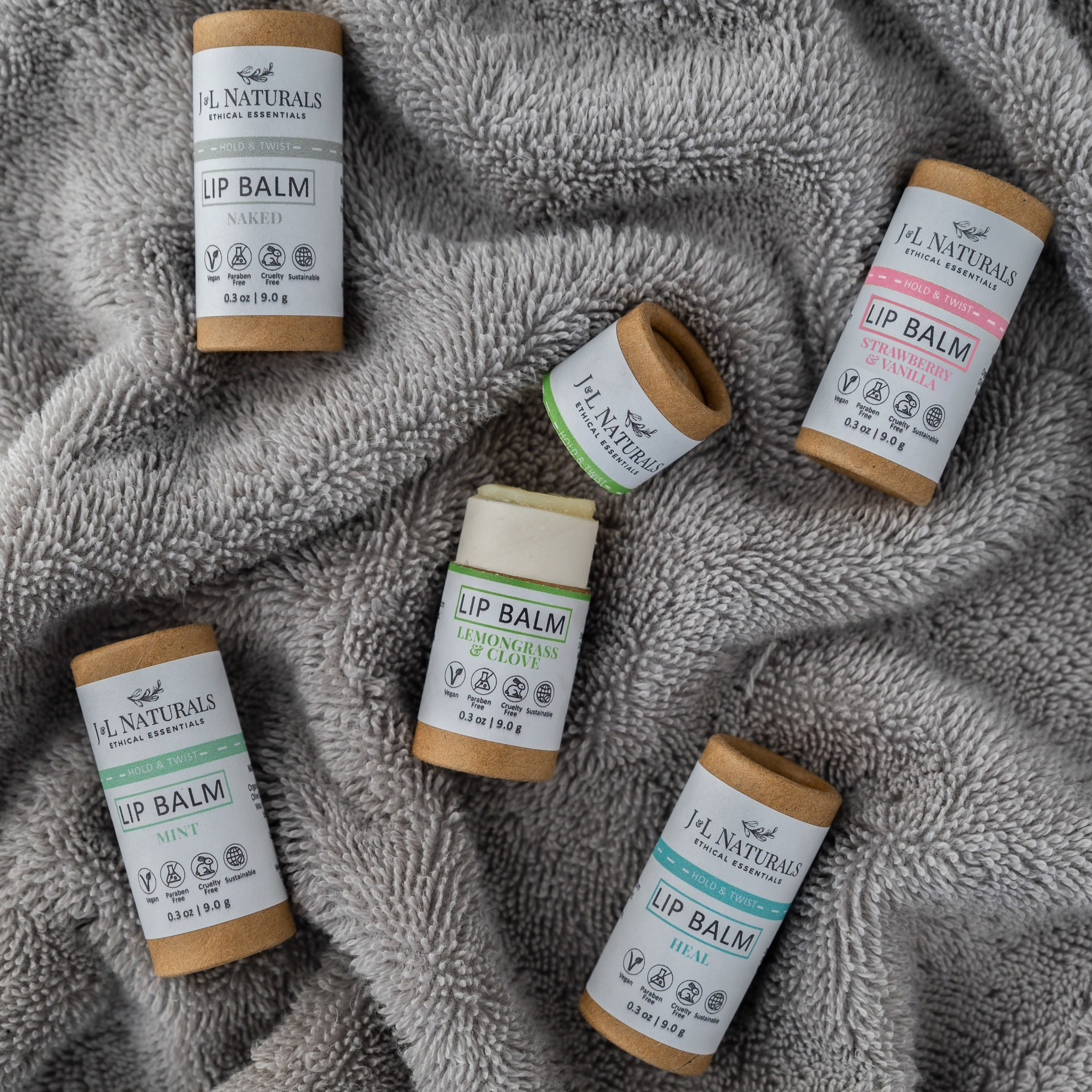 A collection of five lip balms in various flavors, showcasing their vibrant packaging and natural ingredients.