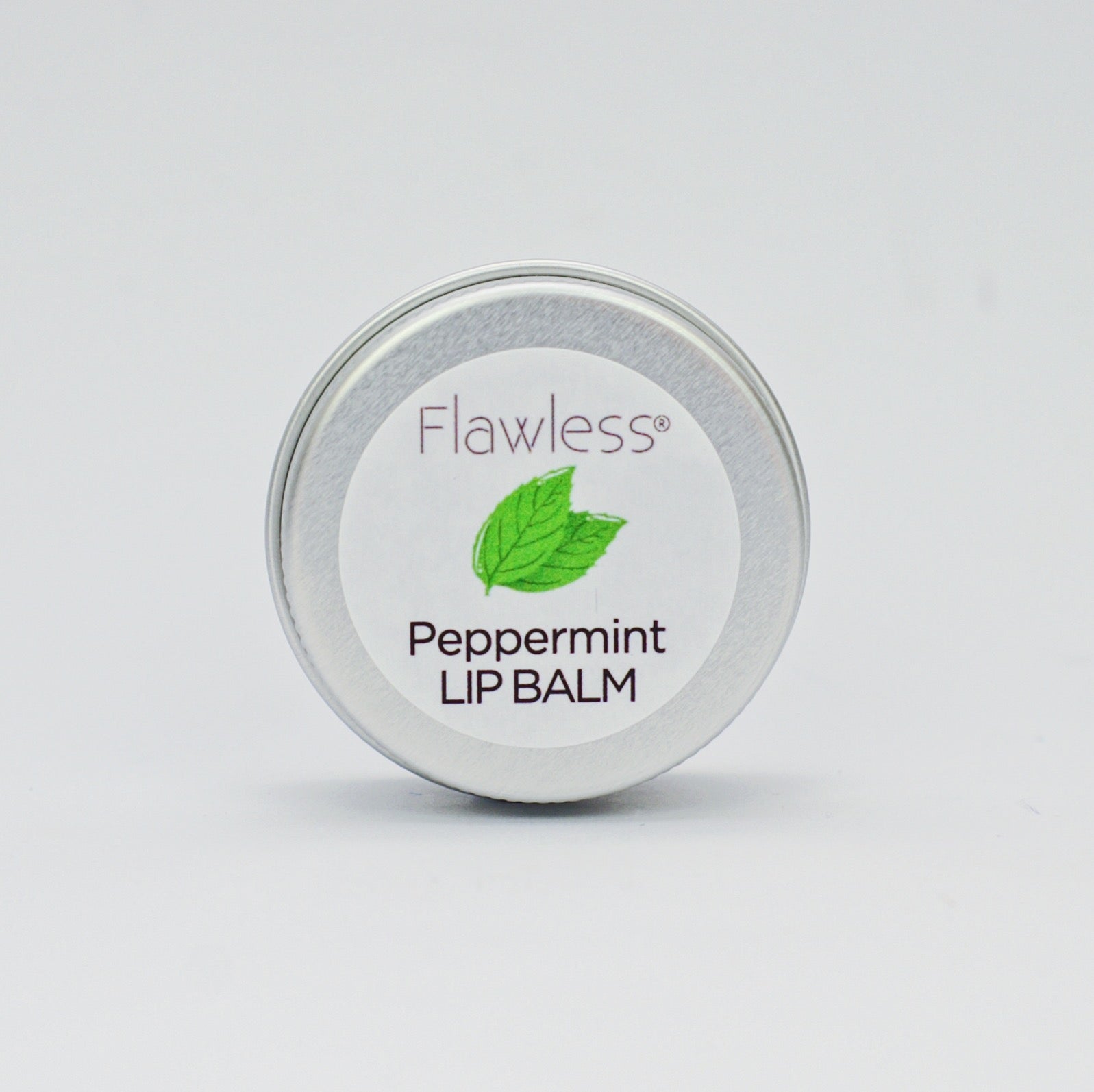 A tin of Peppermint Lip Balm featuring a minty green color, showcasing its eco-friendly packaging and natural ingredients.