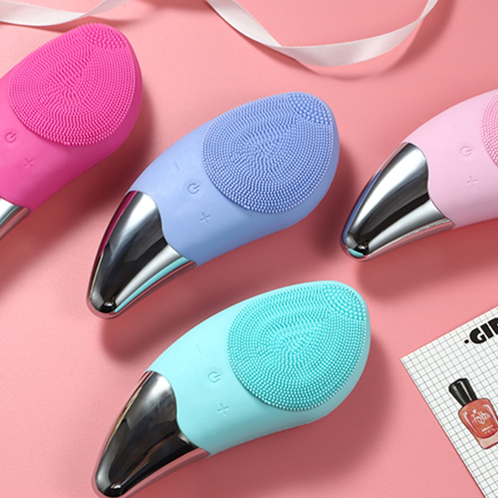 Mini Electric Facial Cleansing Brush in pink color, showcasing its sleek design and soft bristles for deep pore cleansing.