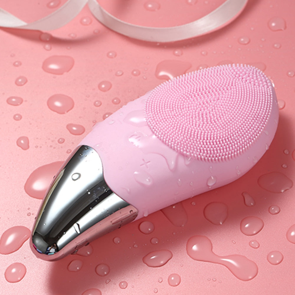 Mini Electric Facial Cleansing Brush in pink color, showcasing its sleek design and soft bristles for deep pore cleansing.