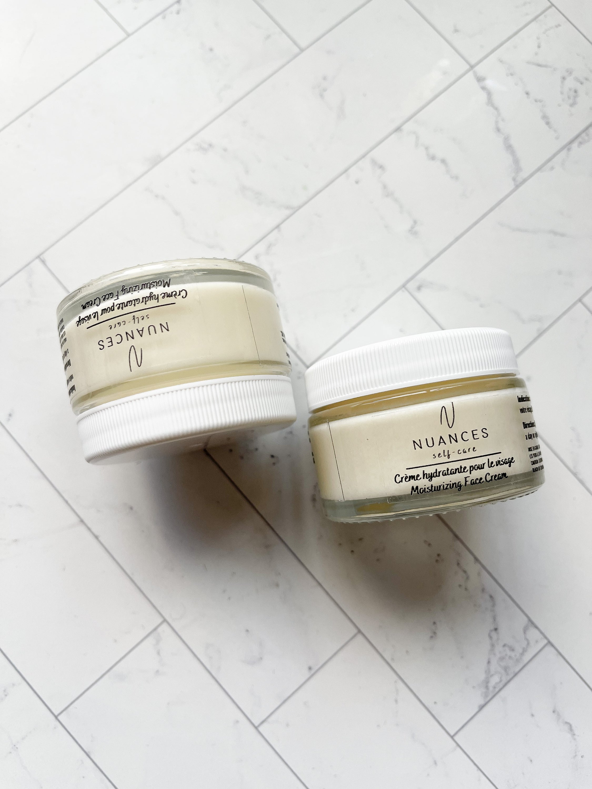 Moisturizing Face Cream in a sleek jar, showcasing its rich texture and natural ingredients like niacinamide and jojoba oil.