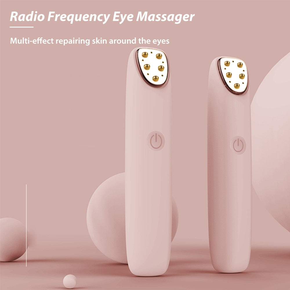 Multi-functional RF Eye Massager in pink color, designed for reducing wrinkles and dark circles around the eyes, featuring a sleek and ergonomic design.