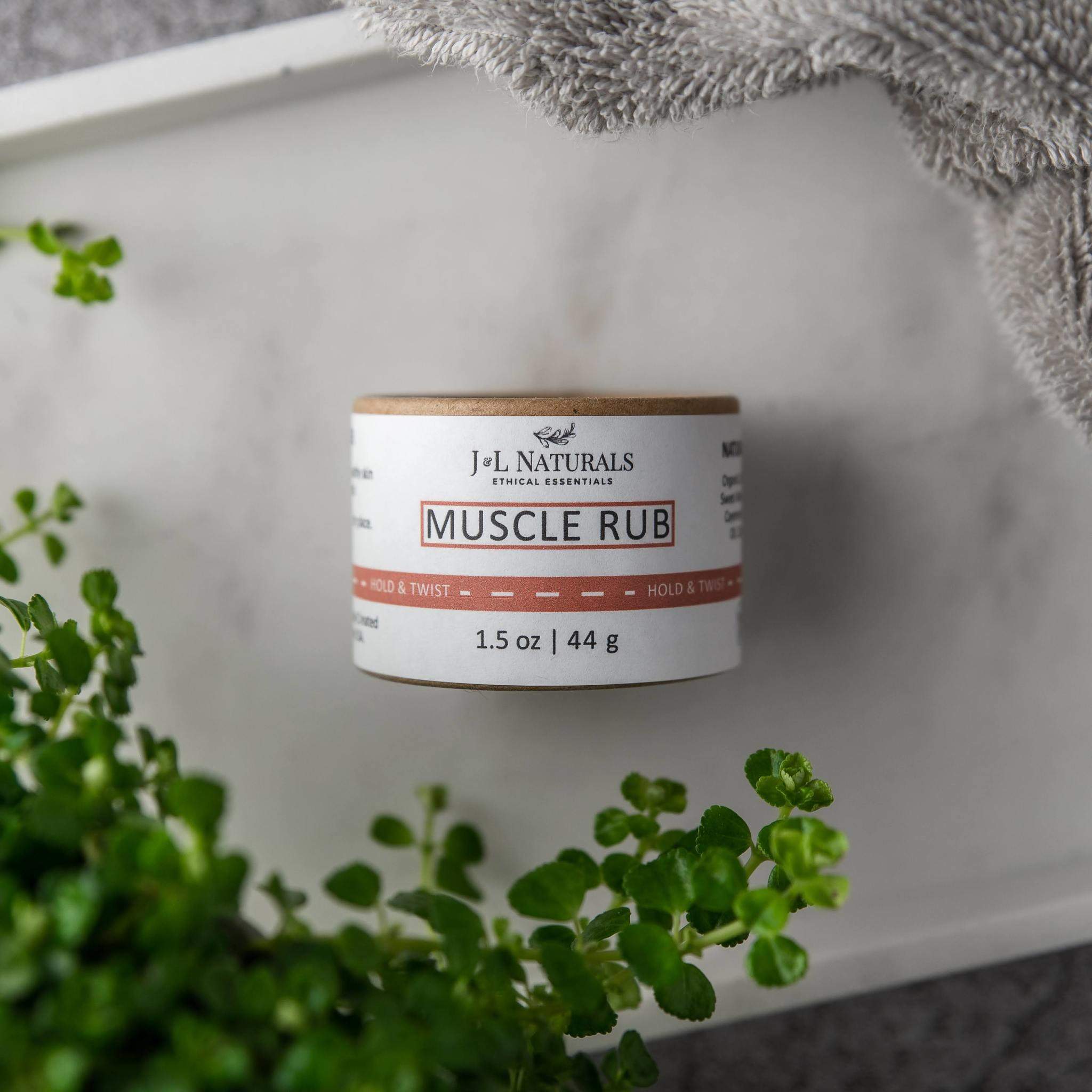 A 1.5 oz jar of Muscle Rub featuring a blend of natural oils and butters for soothing sore muscles and nourishing skin.