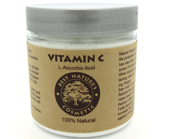 Natural Vitamin C Powder in a clear container, showcasing its fine white crystalline texture, ideal for skincare formulations.