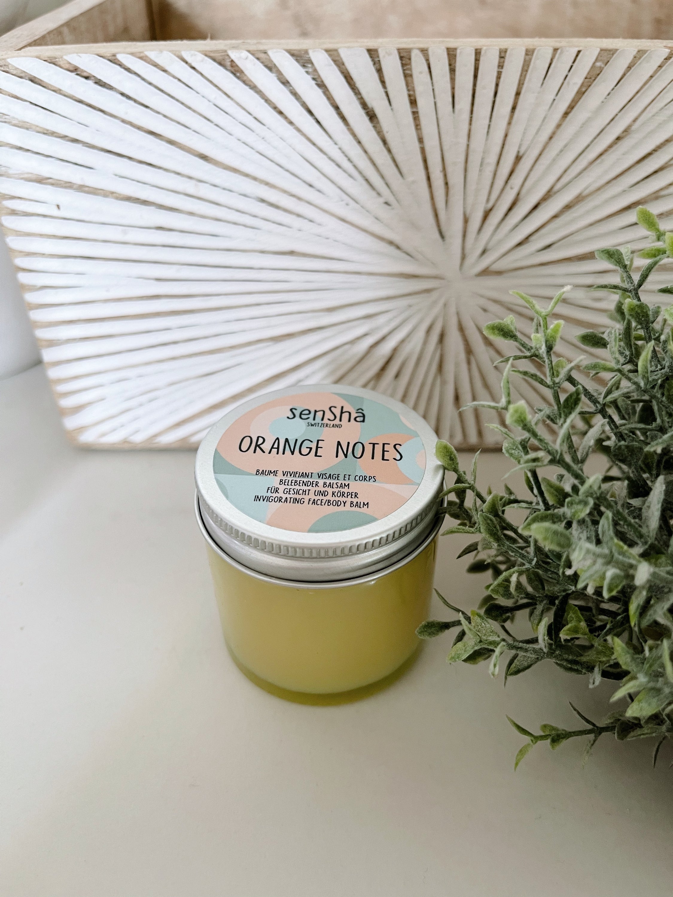 Orange Notes 60ml balm in a sleek container, showcasing its vibrant orange color and luxurious texture.