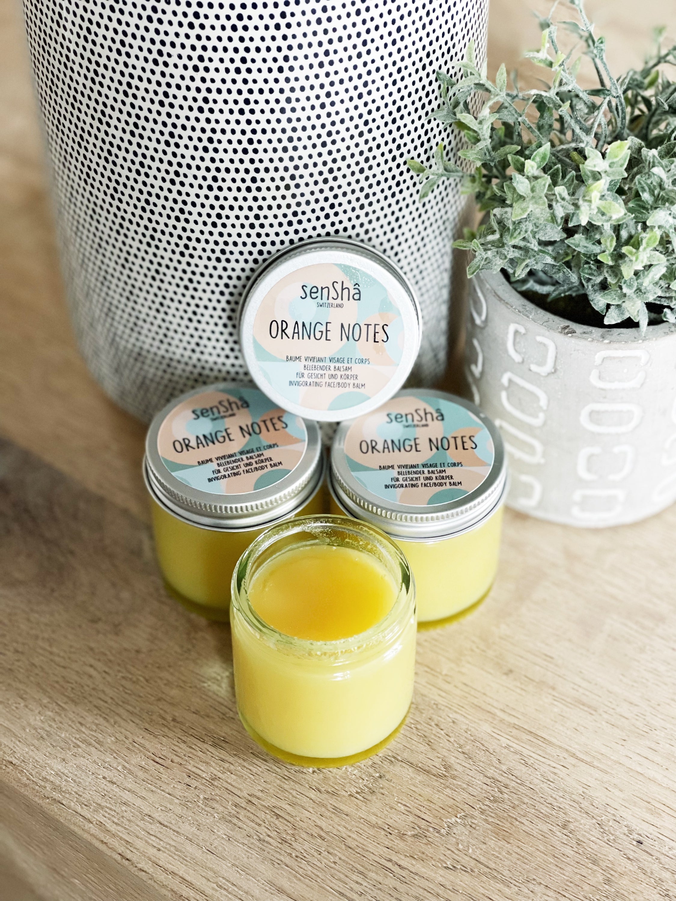 Orange Notes 60ml balm in a sleek container, showcasing its vibrant orange color and luxurious texture.