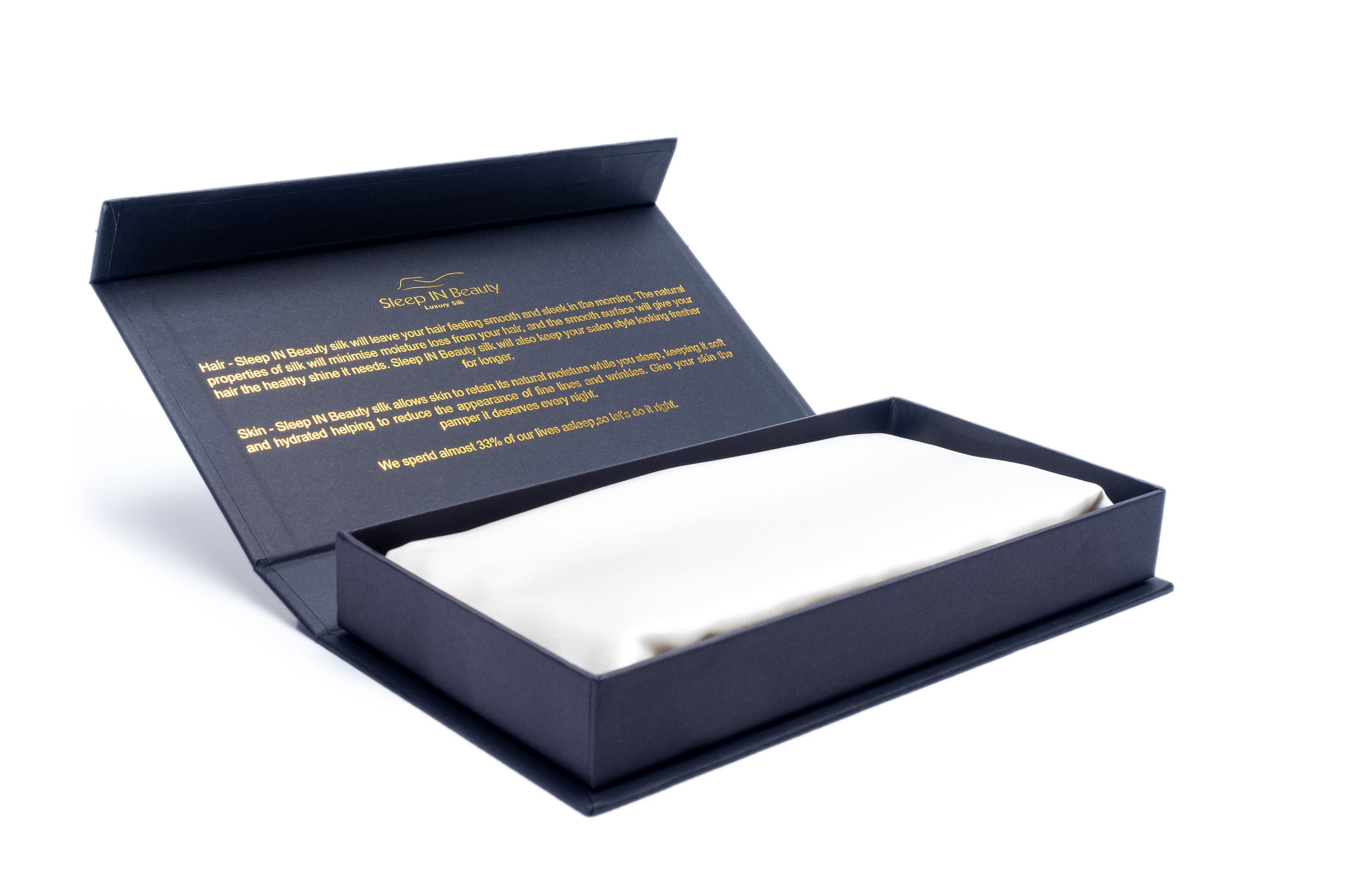 A pair of luxurious SIB™ silk pillowcases in elegant black and gold gift boxes, showcasing their soft texture and hidden zipper design.