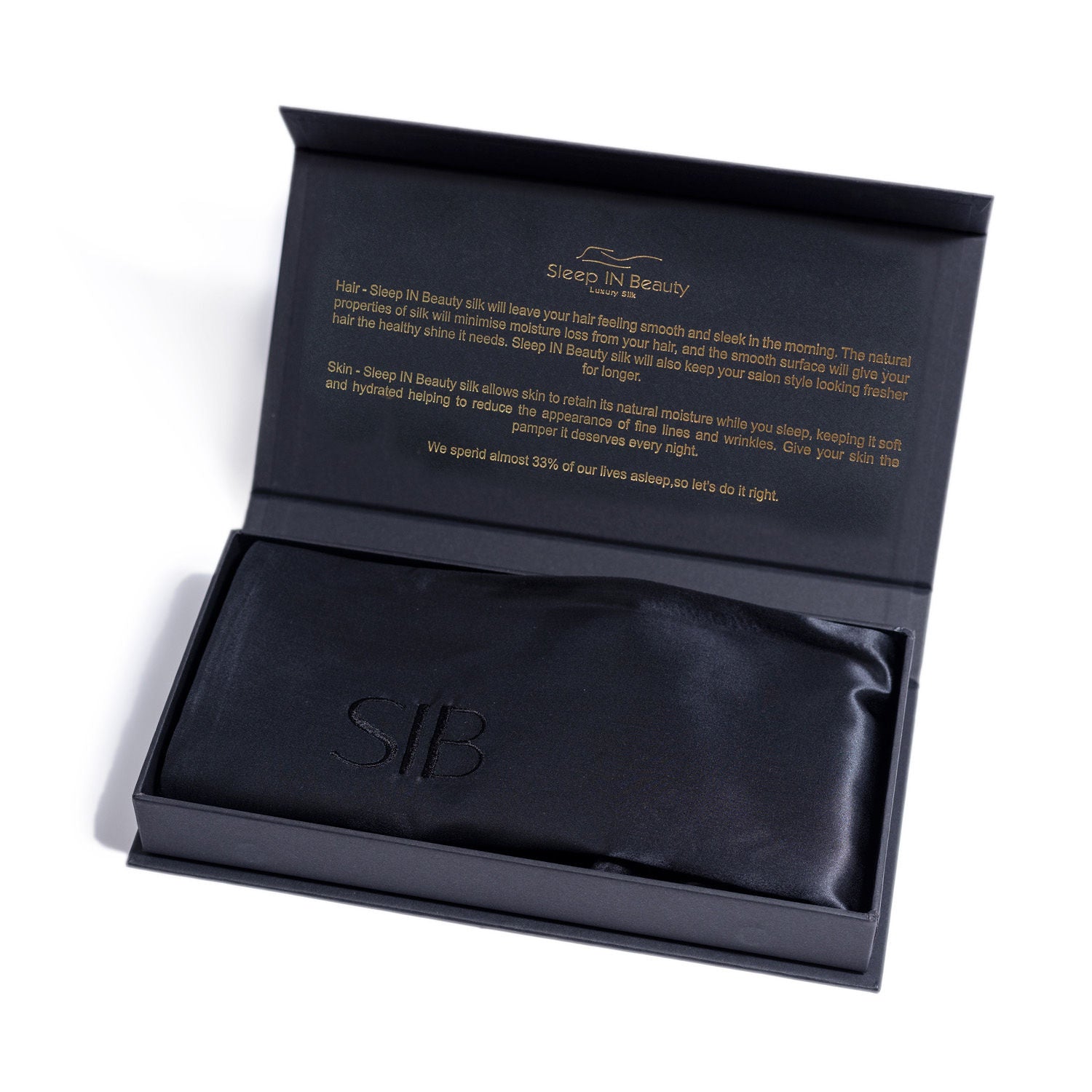 A pair of luxurious SIB™ silk pillowcases in elegant black and gold gift boxes, showcasing their soft texture and hidden zipper design.