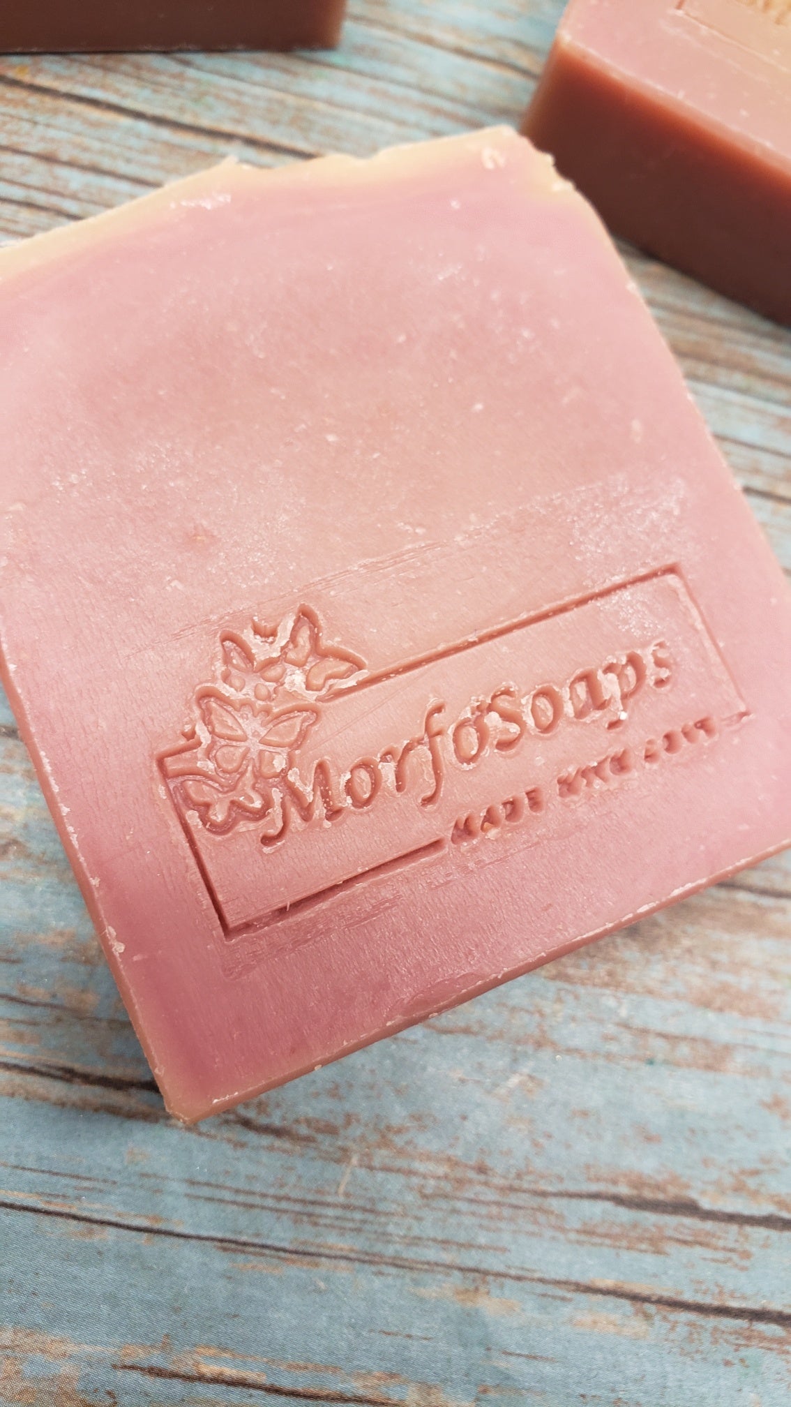 A bar of MorfoSoaps' Papaya Soap, showcasing its vibrant color and unique texture, made with real papaya extract and tropical fragrance.