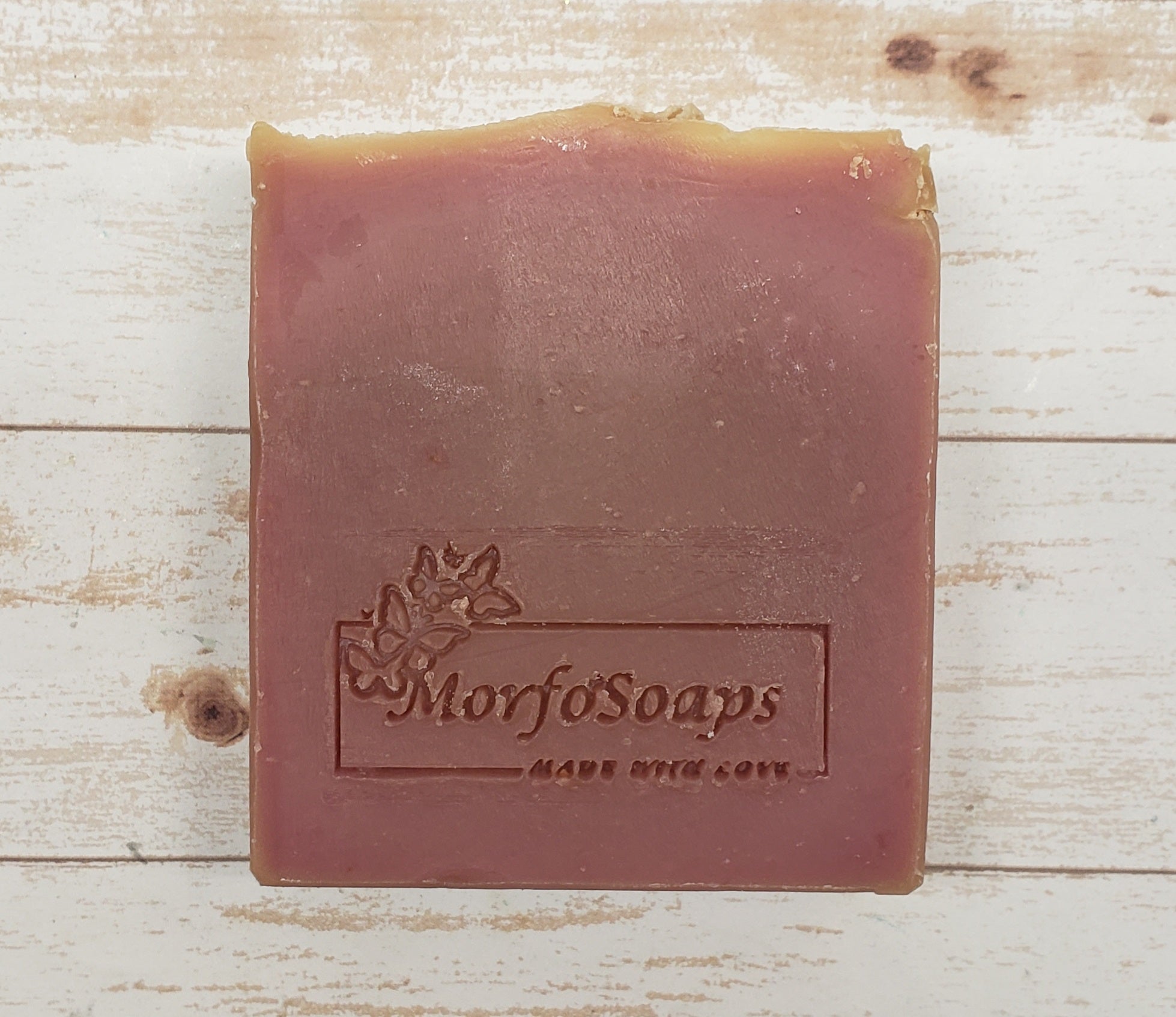 A bar of MorfoSoaps' Papaya Soap, showcasing its vibrant color and unique texture, made with real papaya extract and tropical fragrance.