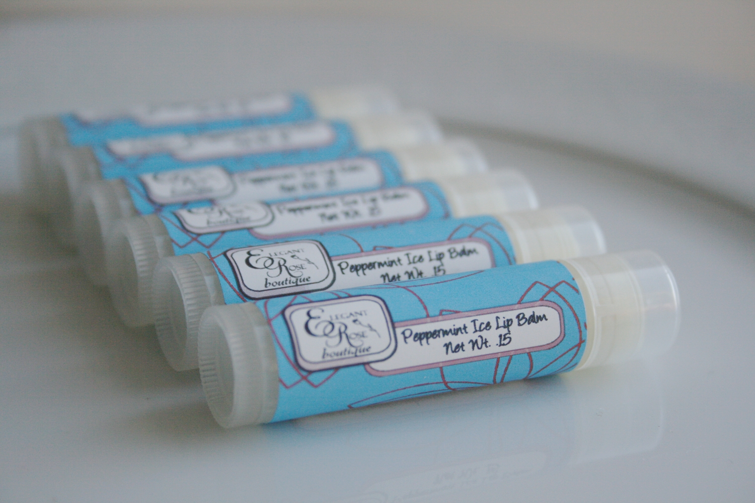 A tube of Peppermint Ice Lip Balm with a minty fresh design, showcasing its refreshing peppermint essence.