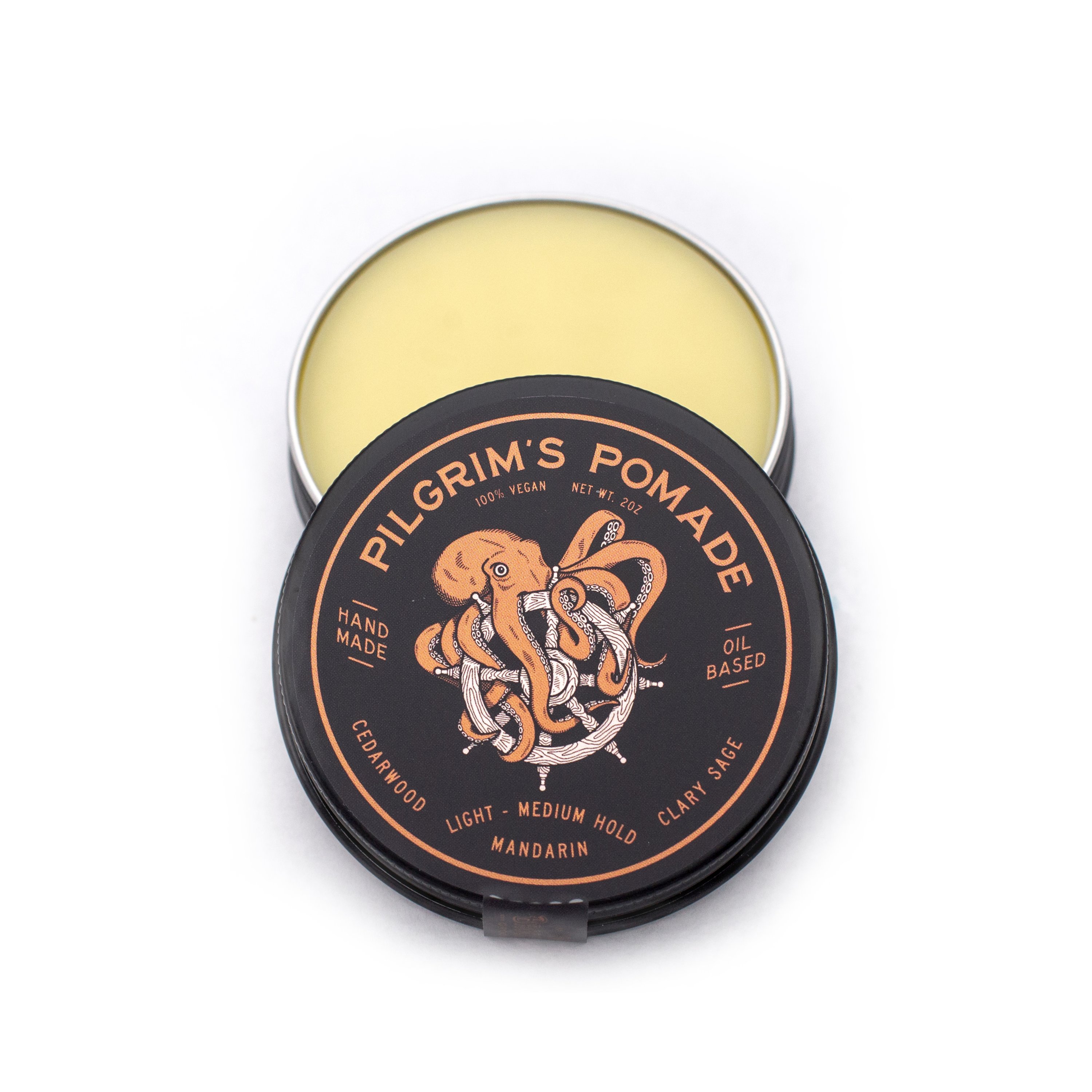 Pilgrim's® Vegan Pomade in a matte black travel tin, featuring a blend of mandarin and clary sage scents.