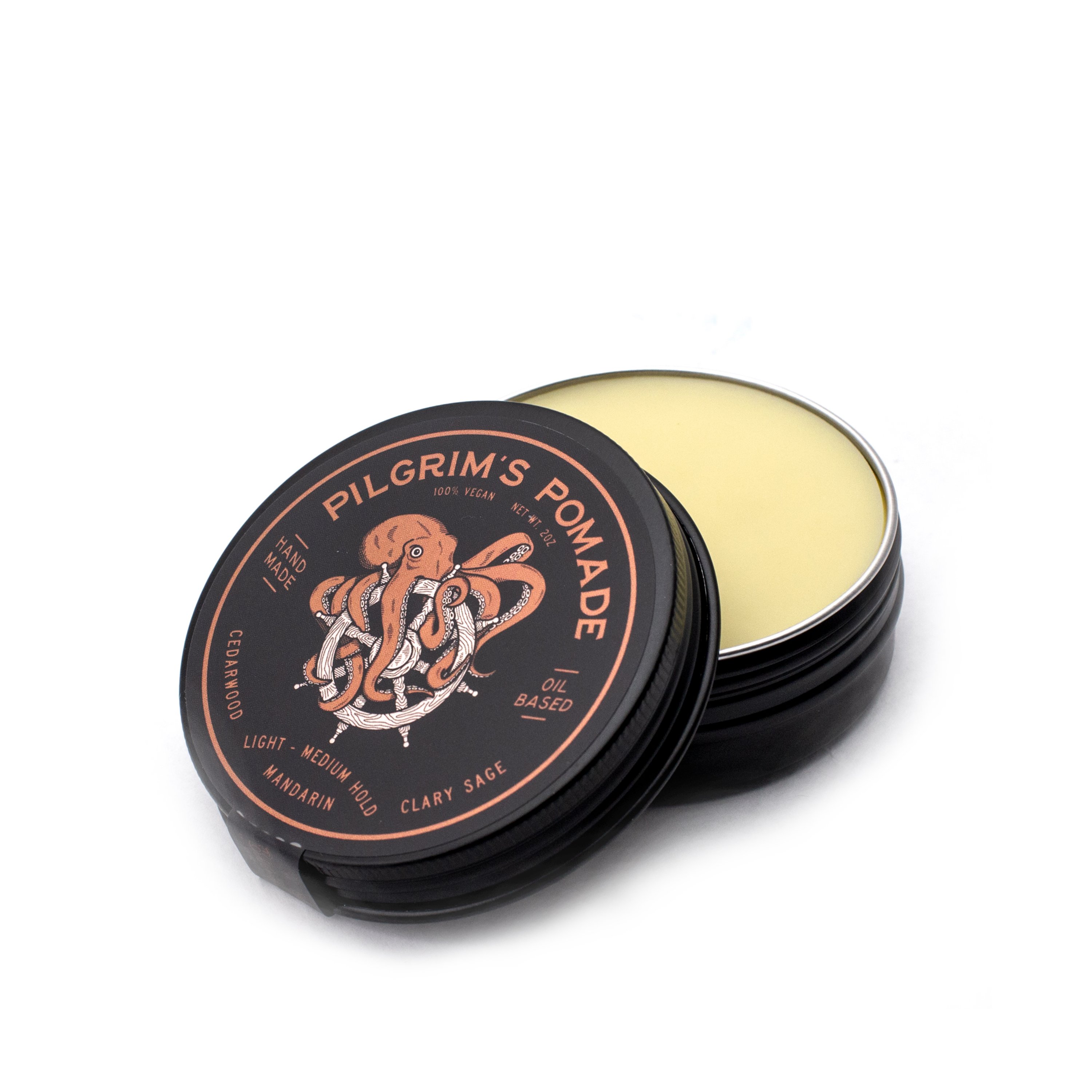 Pilgrim's® Vegan Pomade in a matte black travel tin, featuring a blend of mandarin and clary sage scents.