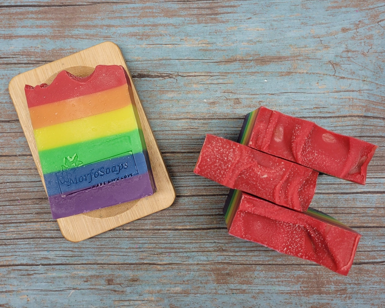 A vibrant bar of Rainbow Soap by Morfosoaps showcasing colorful layers and a fresh scent, handcrafted with natural oils.