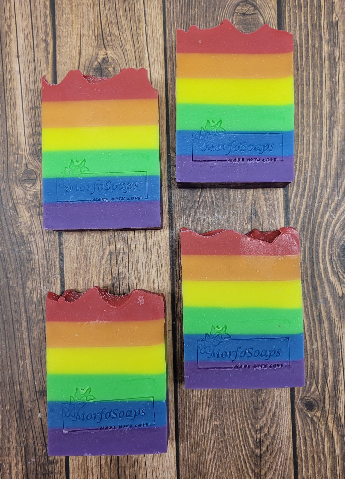 A vibrant bar of Rainbow Soap by Morfosoaps showcasing colorful layers and a fresh scent, handcrafted with natural oils.