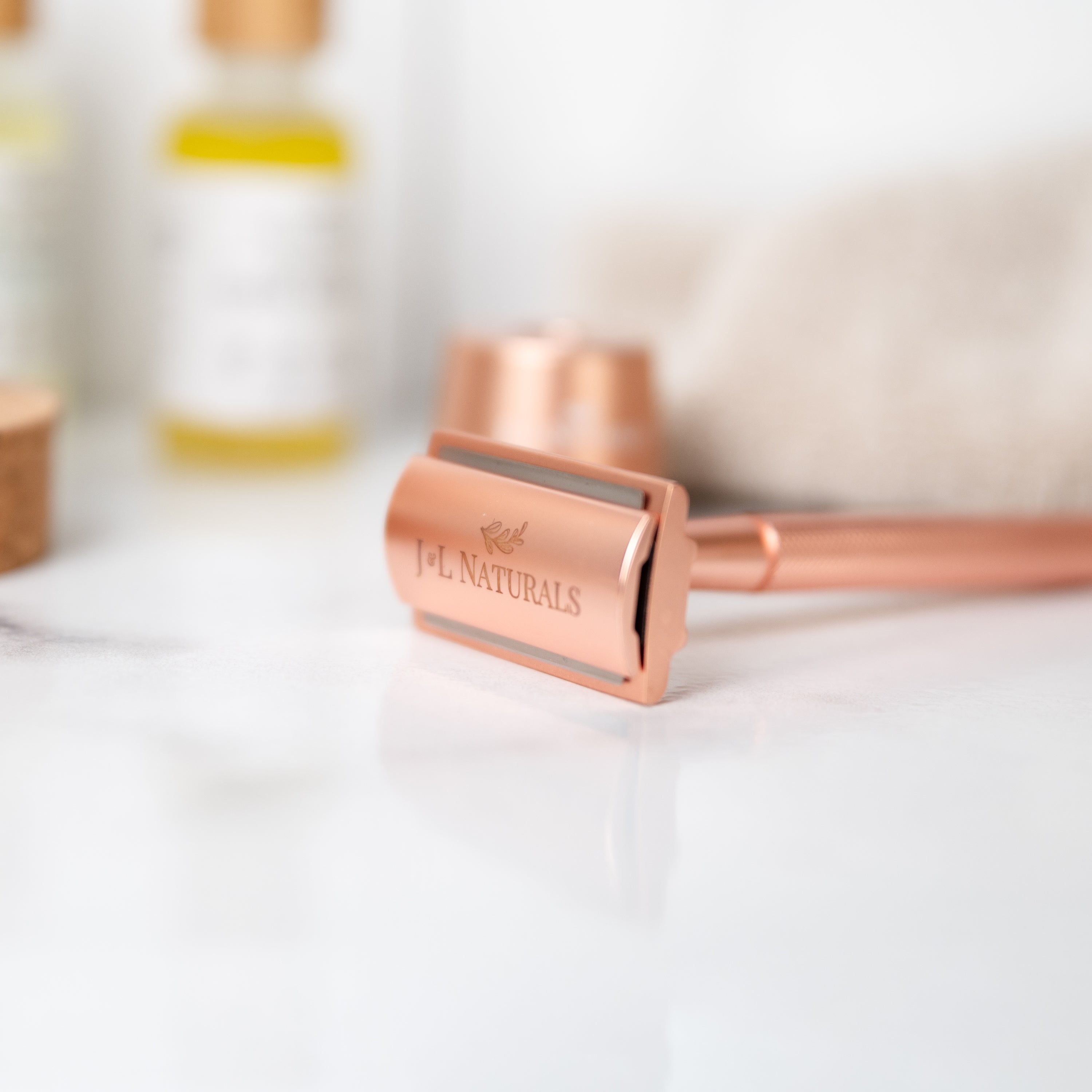 A sleek stainless steel razor set including a double-sided razor and a stylish stand, available in four colors: Black, Rose Gold, Green, and White.