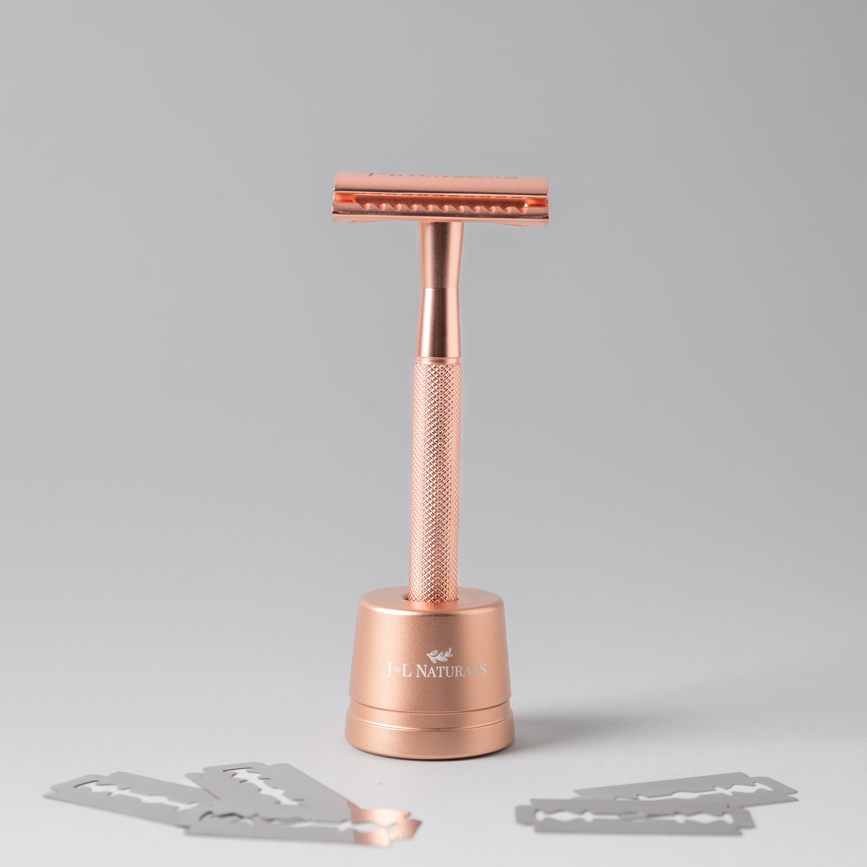 A sleek stainless steel razor set including a double-sided razor and a stylish stand, available in four colors: Black, Rose Gold, Green, and White.