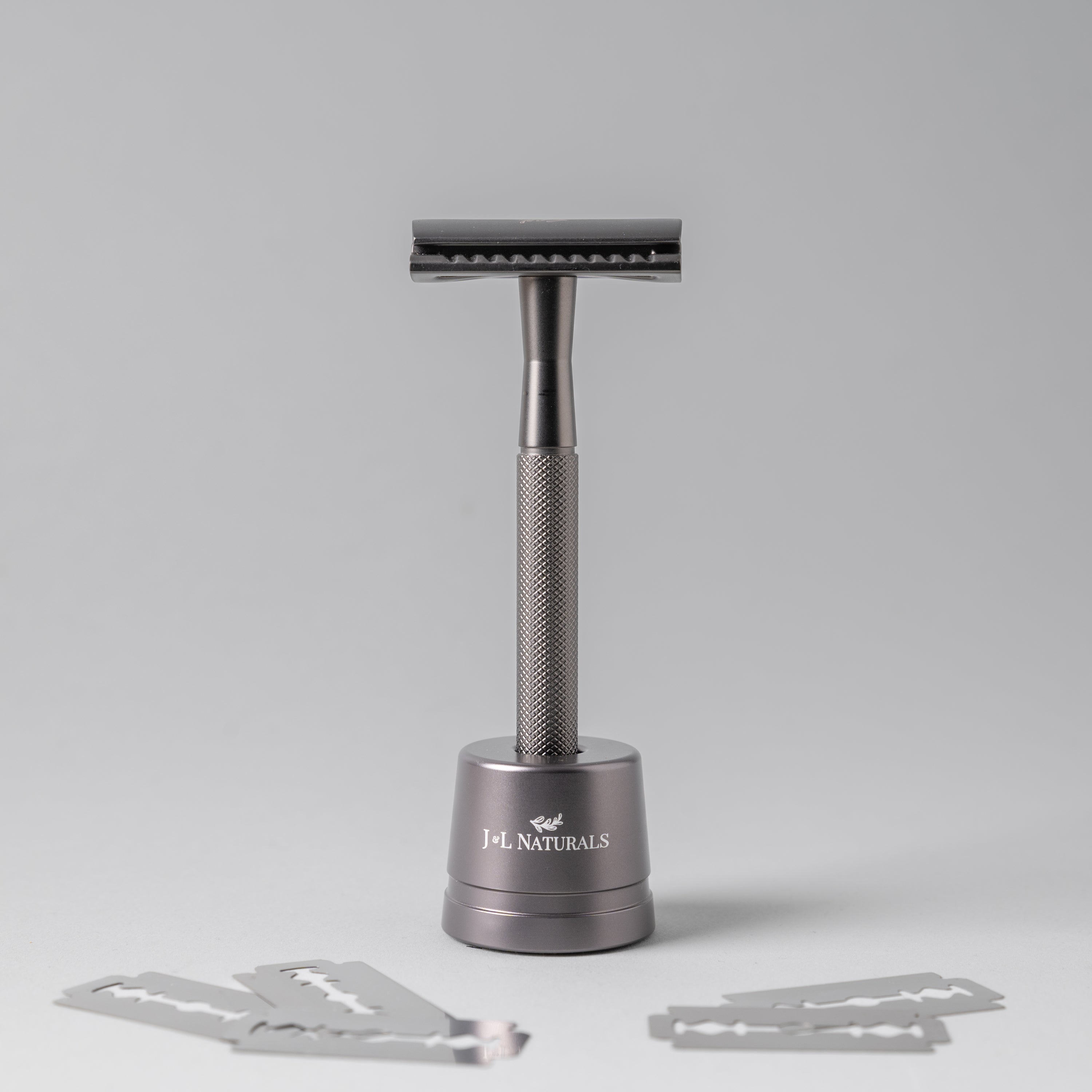 A sleek stainless steel razor set including a double-sided razor and a stylish stand, available in four colors: Black, Rose Gold, Green, and White.