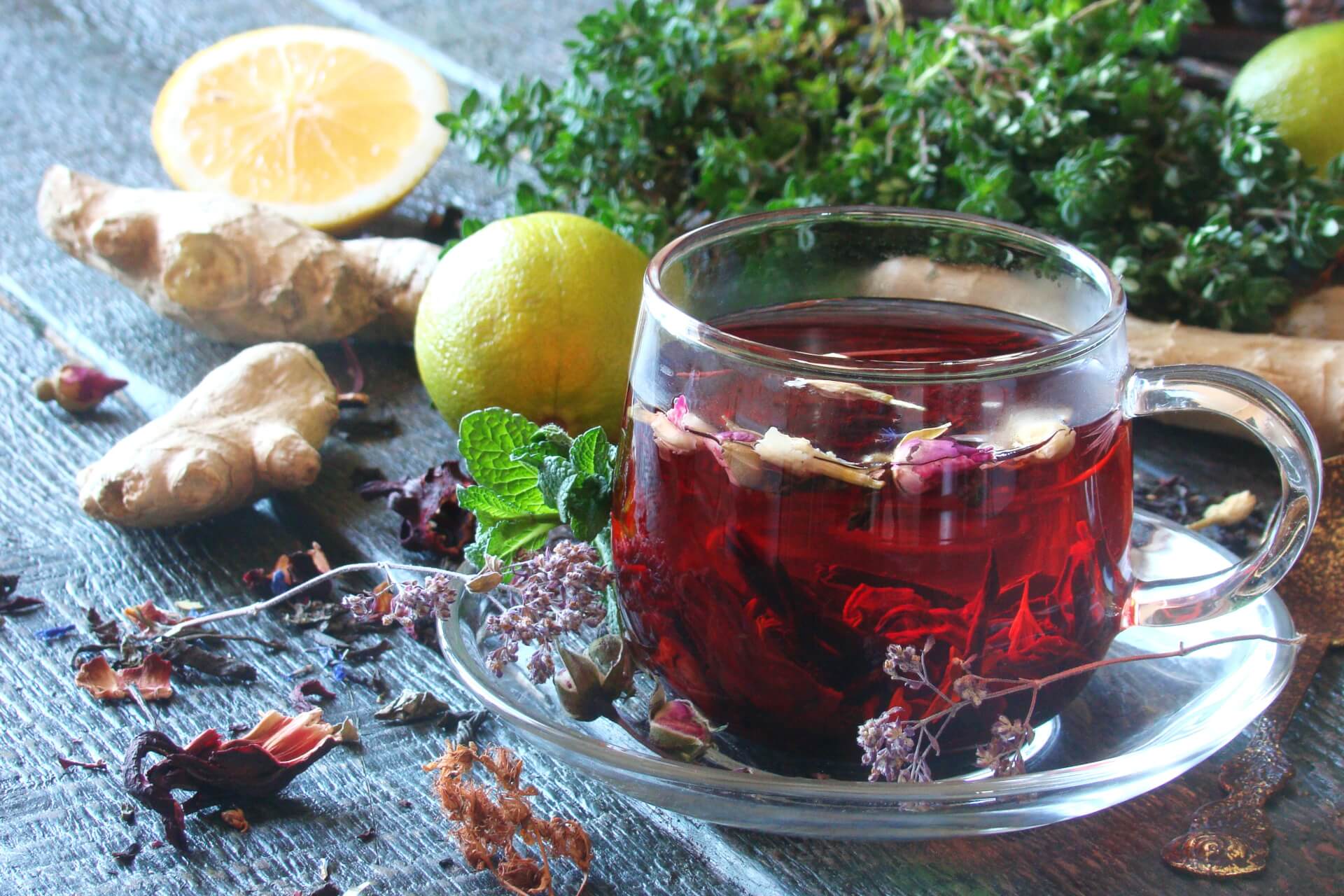 A vibrant red powder mix of hibiscus and ginger, showcasing its rich color and texture, perfect for making natural tea.