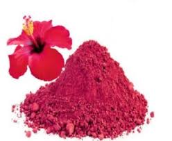 A vibrant red powder mix of hibiscus and ginger, showcasing its rich color and texture, perfect for making natural tea.