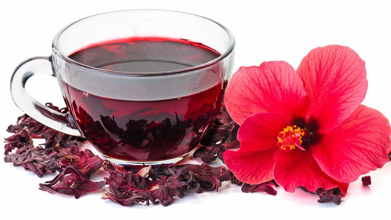 A vibrant red powder mix of hibiscus and ginger, showcasing its rich color and texture, perfect for making natural tea.