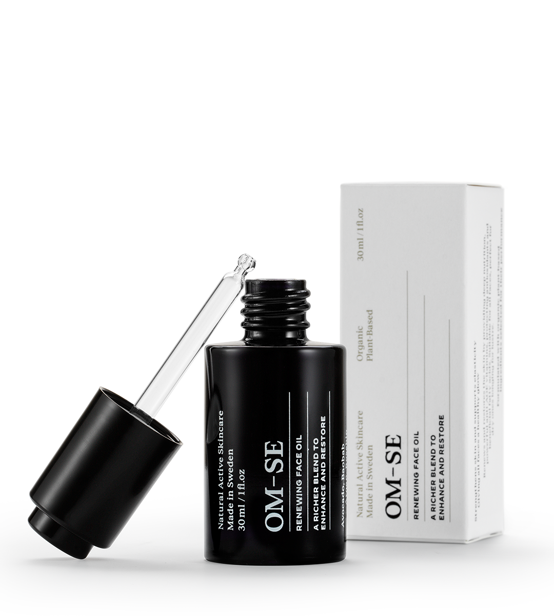 A bottle of Renewing Face Oil with a dropper, showcasing its rich, golden oil texture, surrounded by natural ingredients.