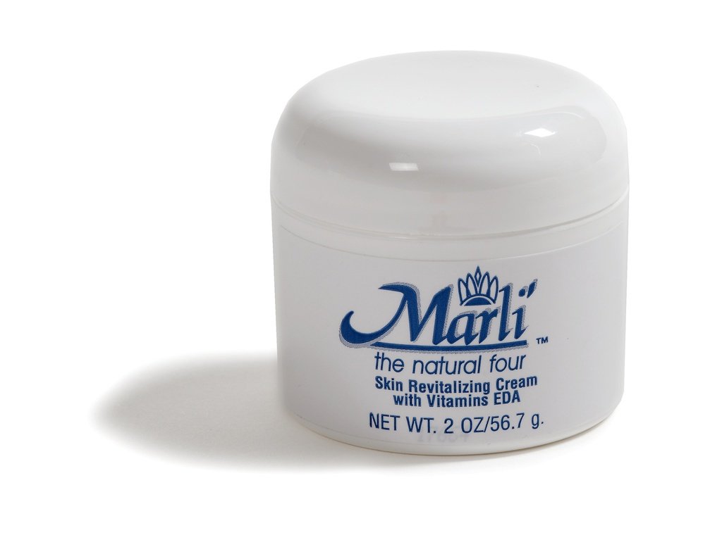 Marli's Revitalizing Vitamin EDA Cream in a sleek jar, showcasing its rich texture and vibrant packaging, ideal for all skin types.