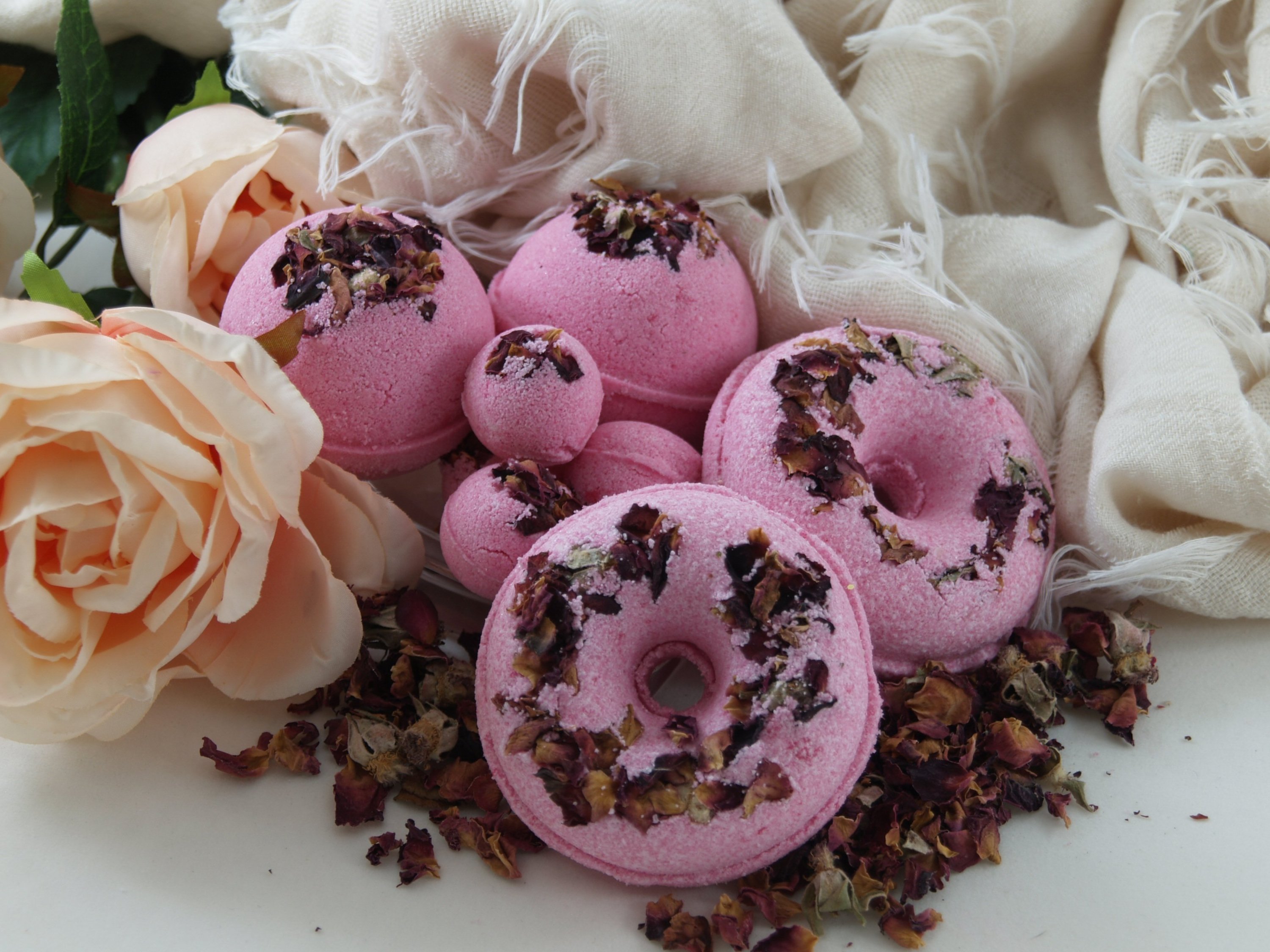 A vibrant Rose Petal Bath Bomb with rose petals, showcasing its colorful and luxurious design, perfect for a relaxing bath experience.