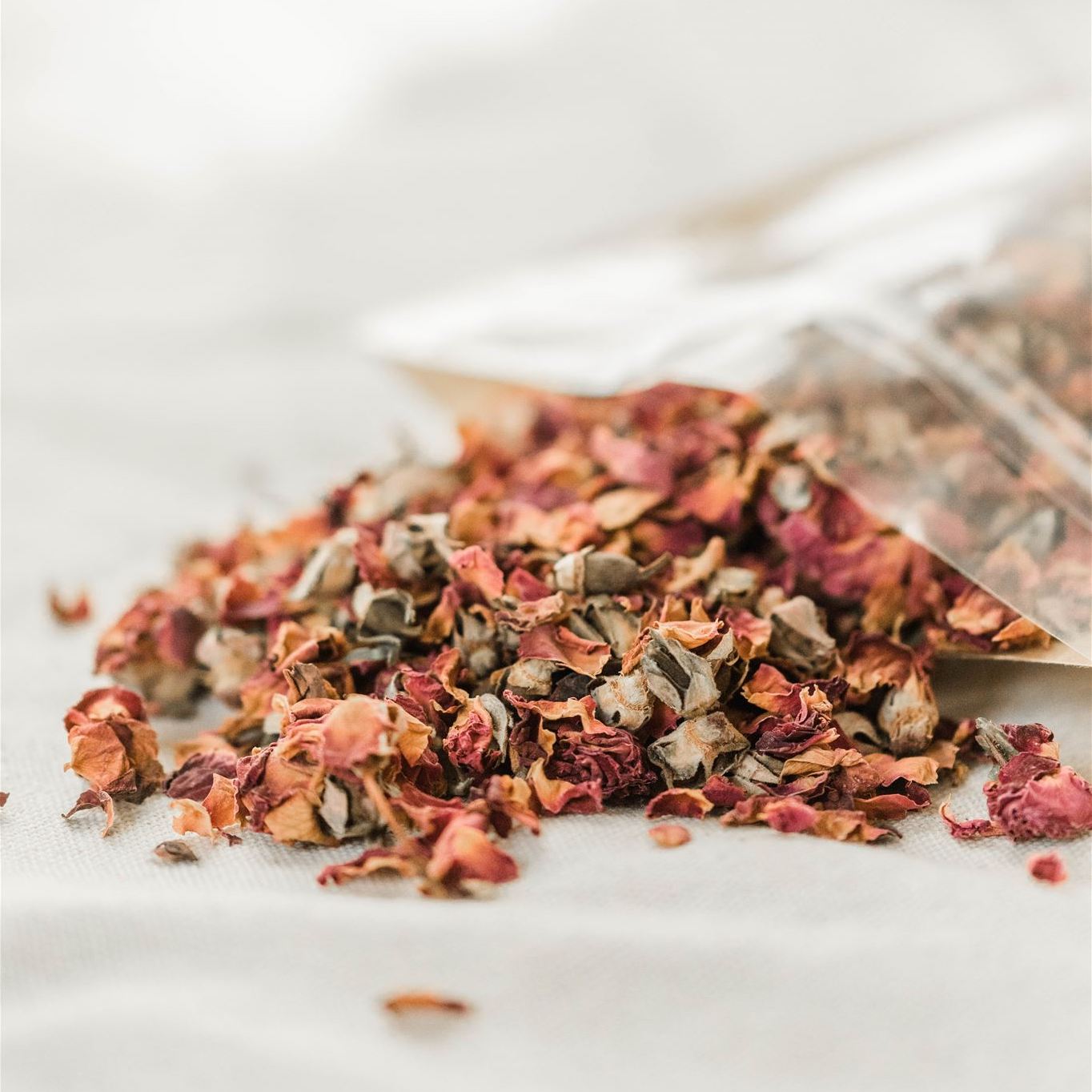 A close-up of vibrant organic dried rose petals, showcasing their rich color and texture, perfect for herbal tea and skincare.