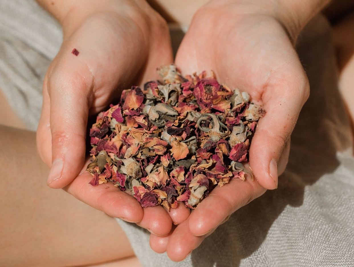 A close-up of vibrant organic dried rose petals, showcasing their rich color and texture, perfect for herbal tea and skincare.