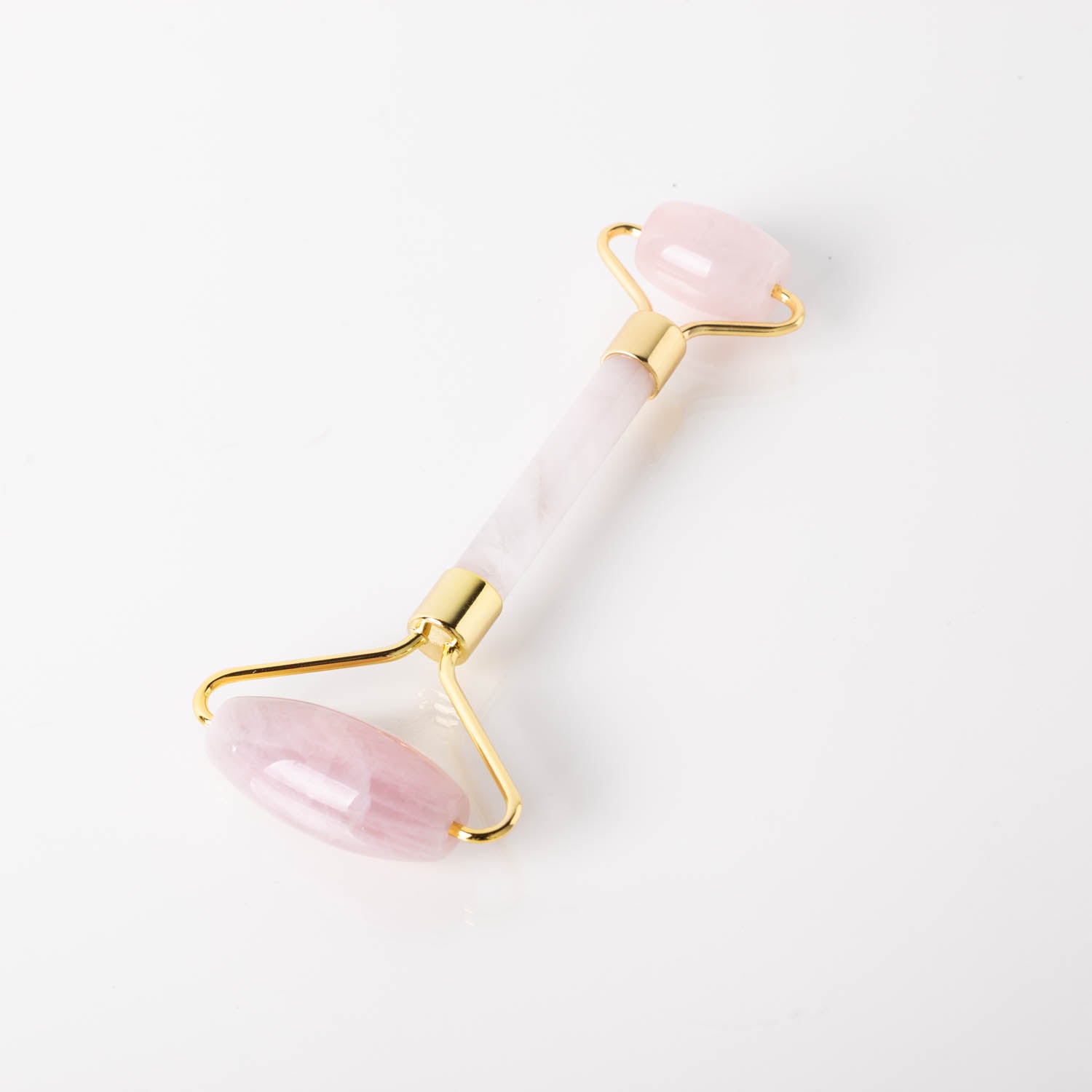 Holysticspa Rose Quartz Face Roller on a marble background, showcasing its elegant design and natural rose quartz stone.