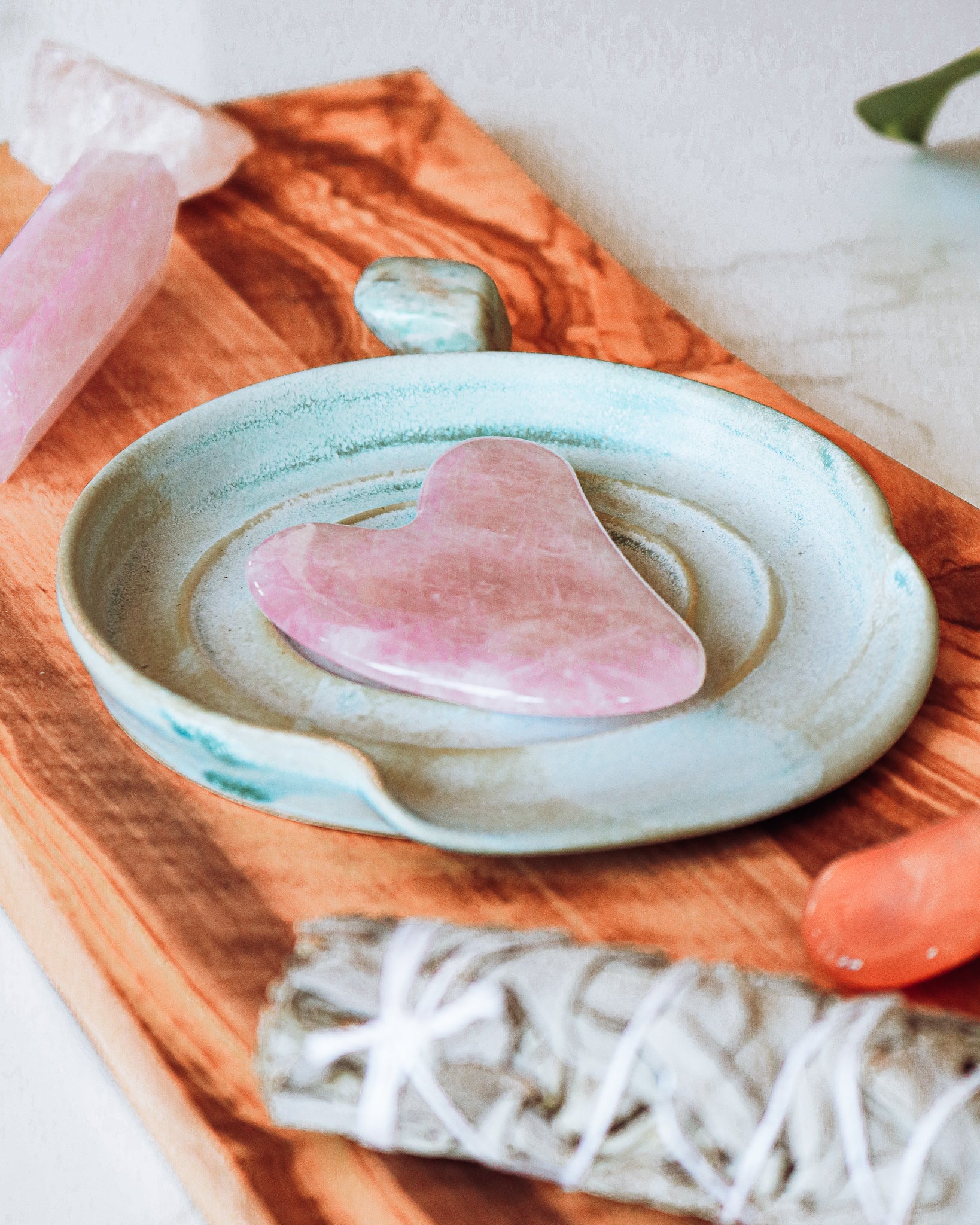 Heart-shaped Rose Quartz Gua Sha tool, showcasing its natural pink hue and unique patterns, perfect for skincare routines.