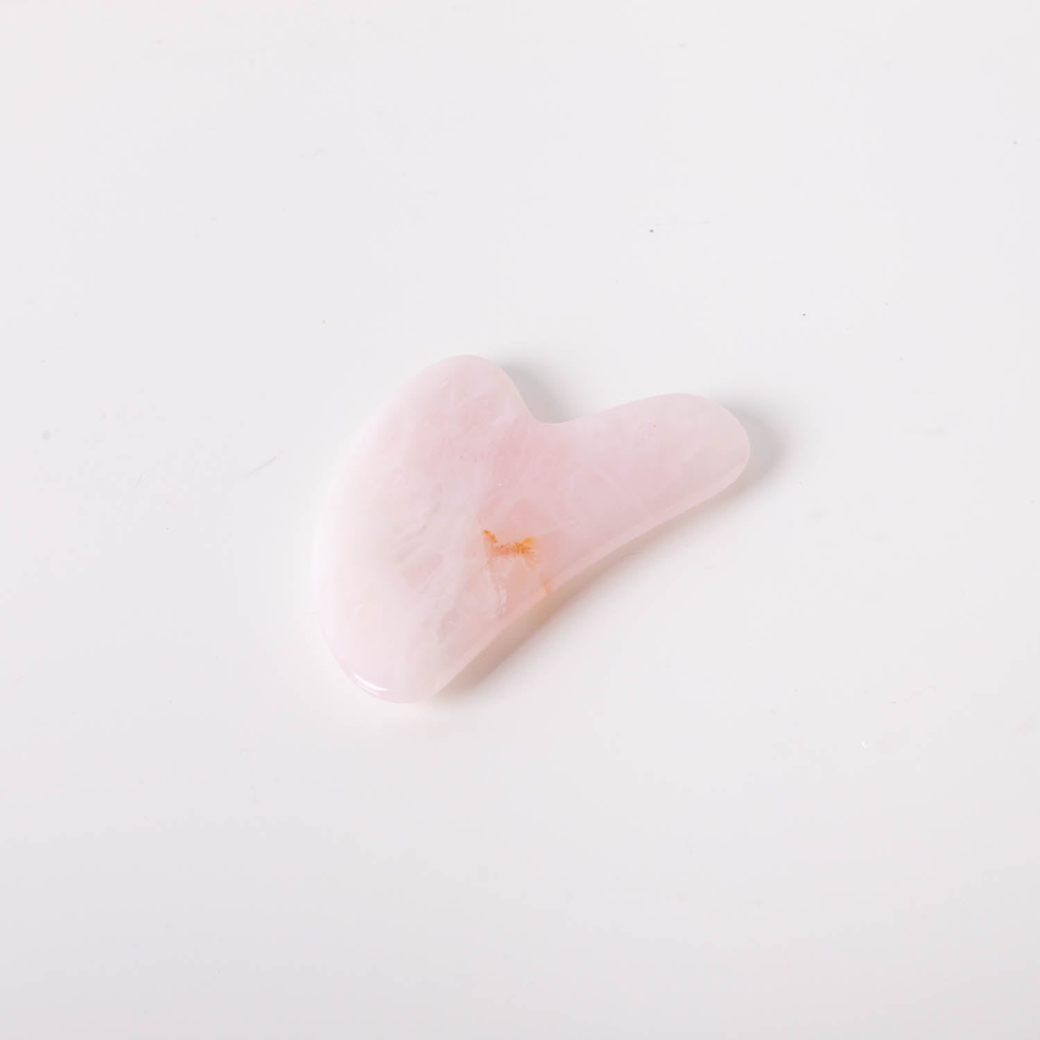 A beautifully crafted Rose Quartz Gua Sha tool, showcasing its smooth surface and elegant pink hue, perfect for facial massage.